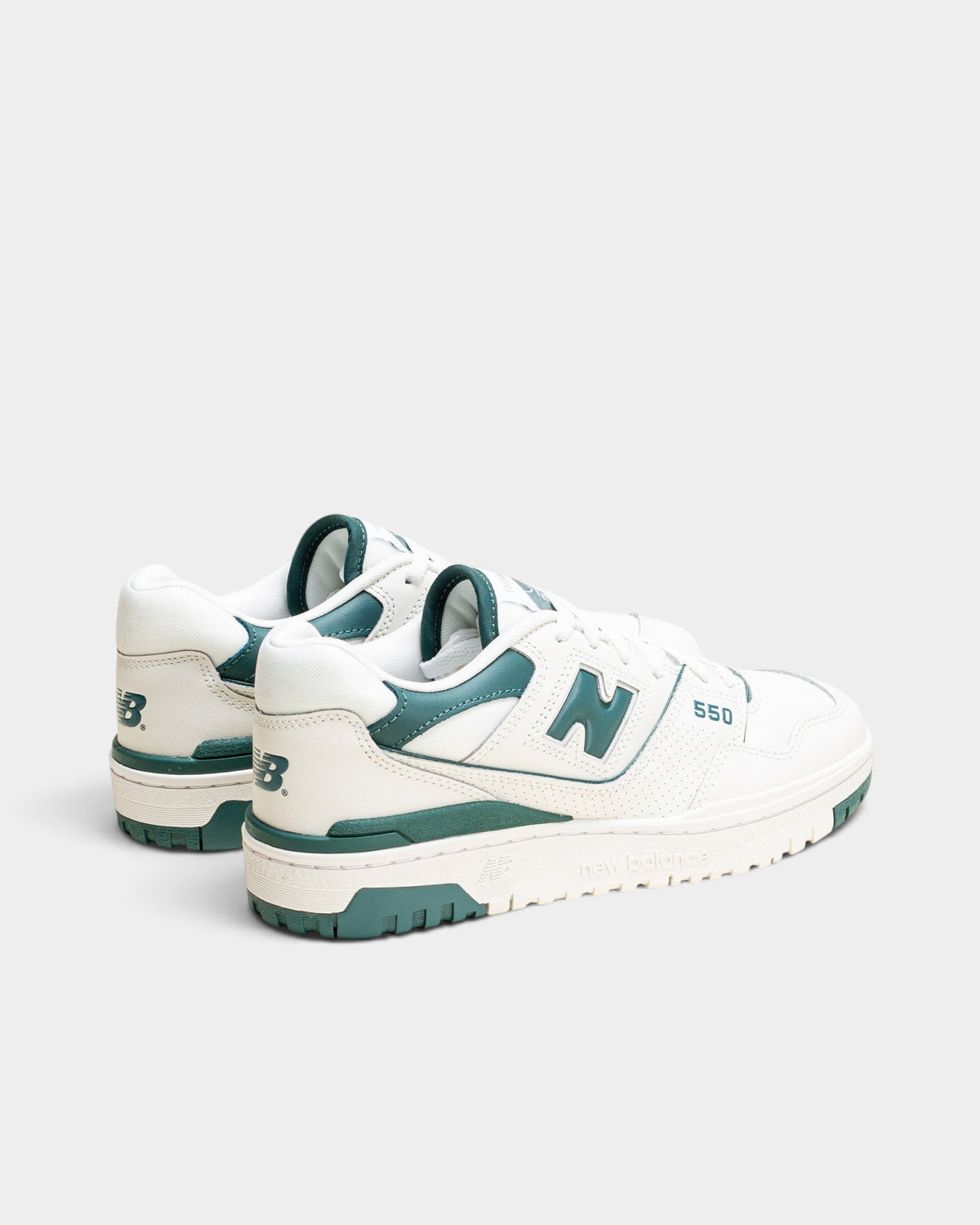 Lockwood Avenue New Balance 550 women's low-top basketball sneakers in white leather with spruce green accents.
