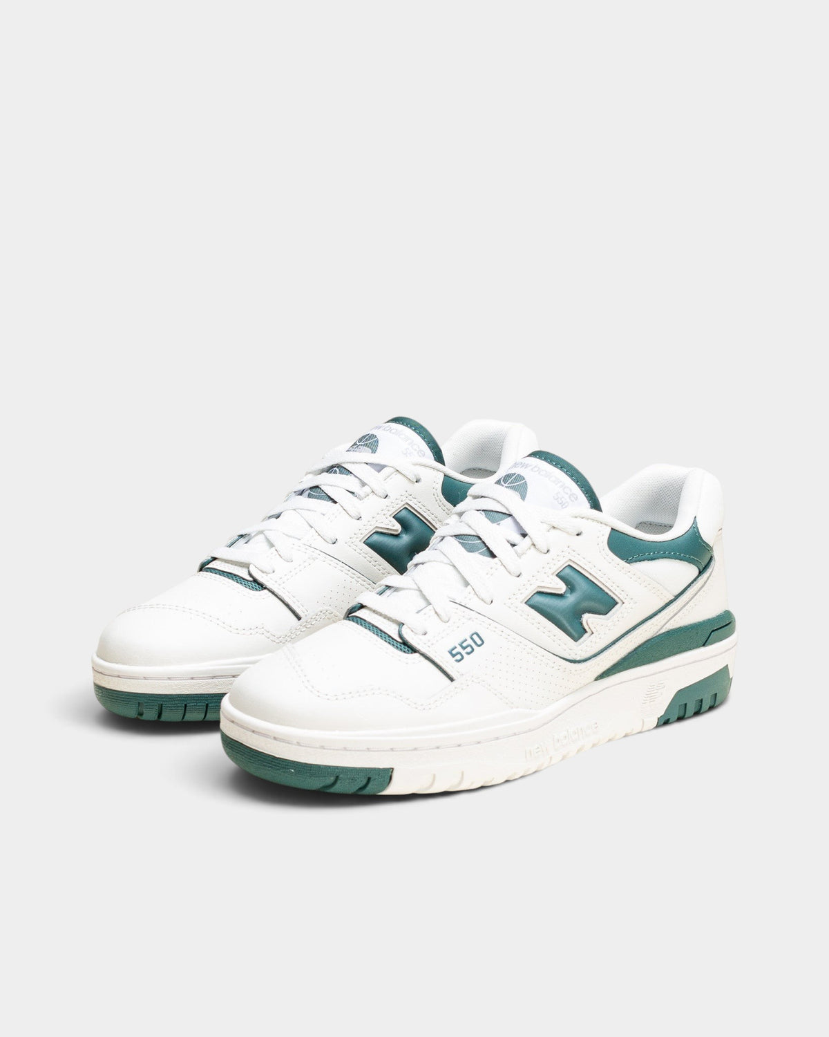 Lockwood Avenue New Balance 550 women's low-top basketball sneakers in white leather with spruce green accents.