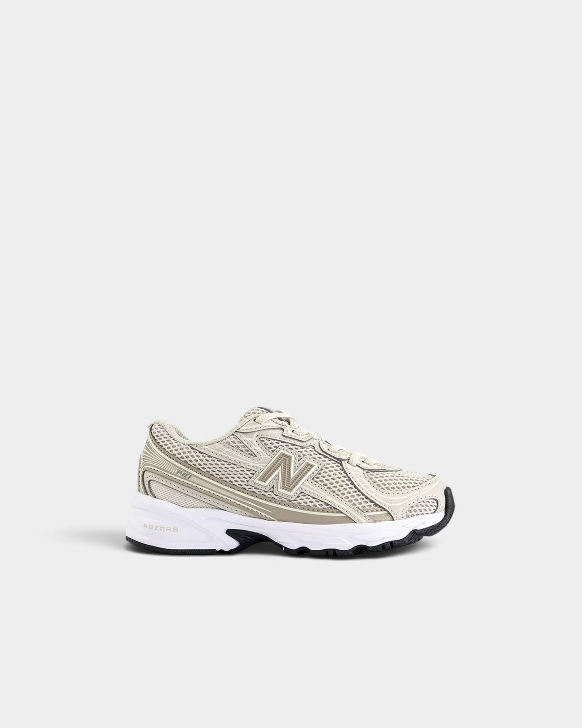 Lockwood Avenue New Balance 740 kids shoes in beige mesh and synthetic with ABZORB cushioning and bungee laces.