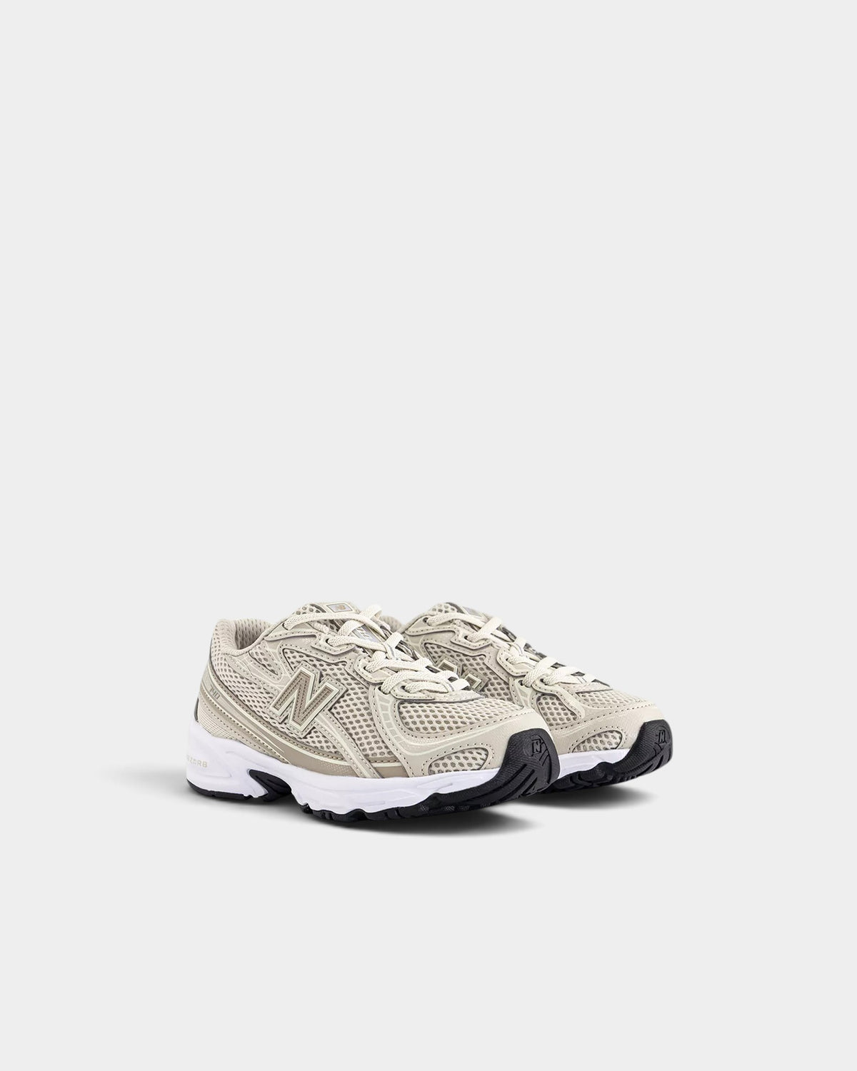 Lockwood Avenue New Balance 740 kids sneakers in beige mesh with synthetic overlays and ABZORB cushioning.