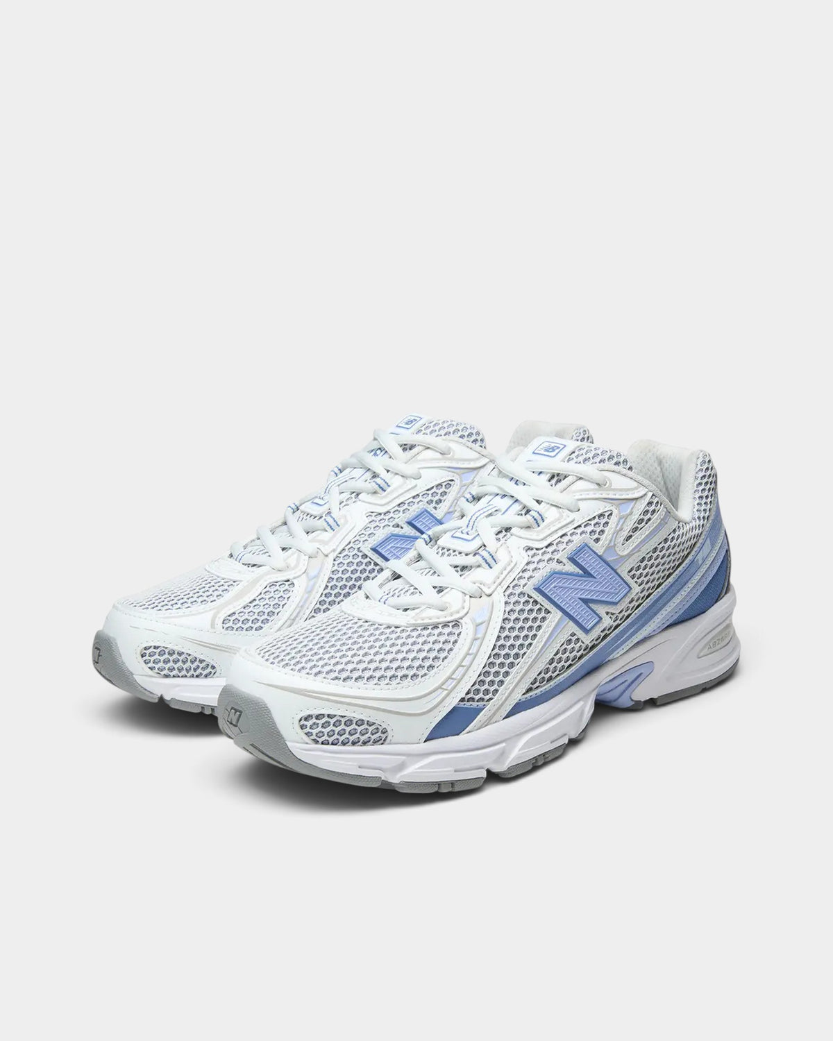 Lockwood Avenue New Balance 740 sneakers in Fairweather Blue and white with open-knit mesh and synthetic overlays.