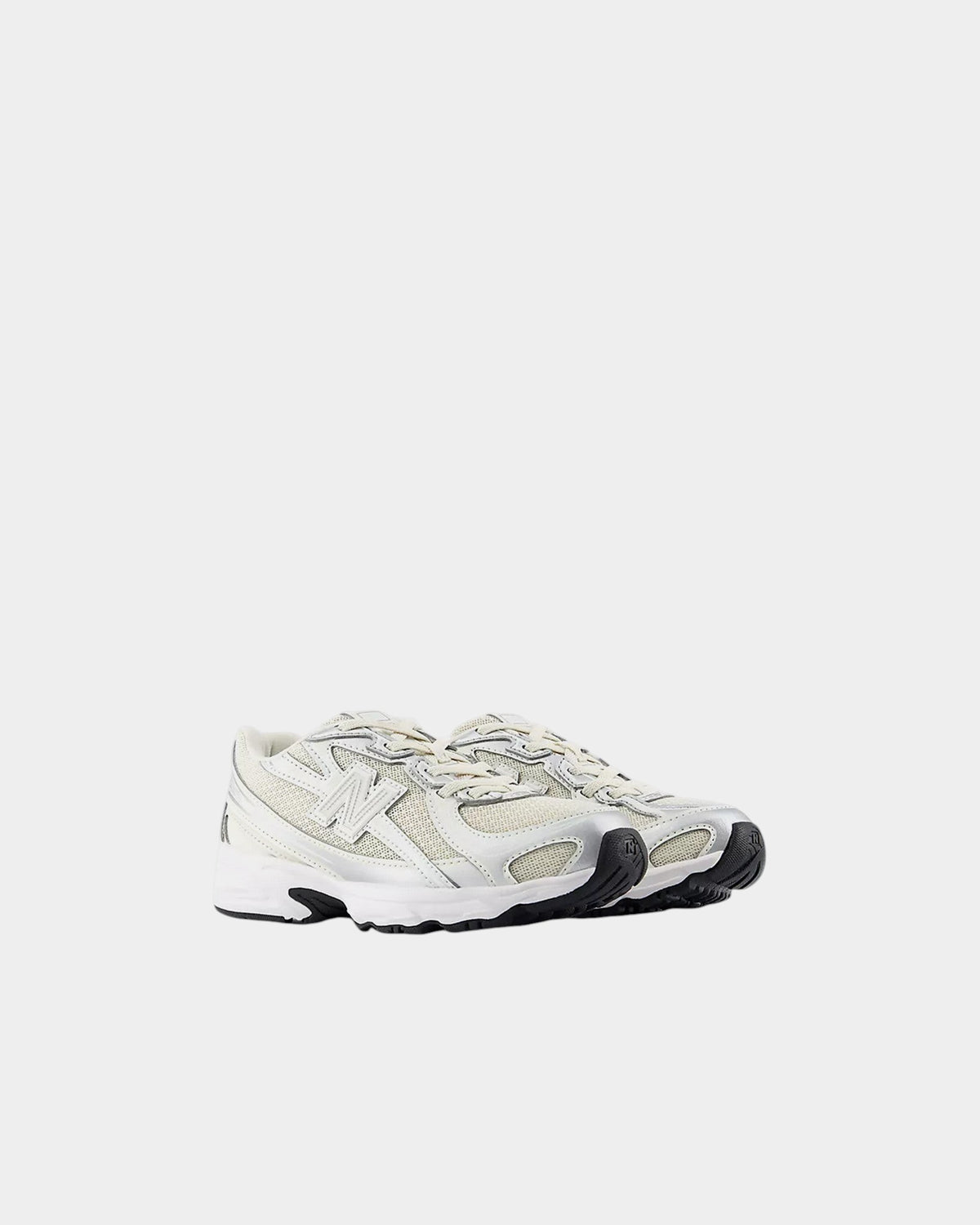 Lockwood Avenue New Balance 740 kids sneakers featuring a silver and white mesh upper with angular overlays.