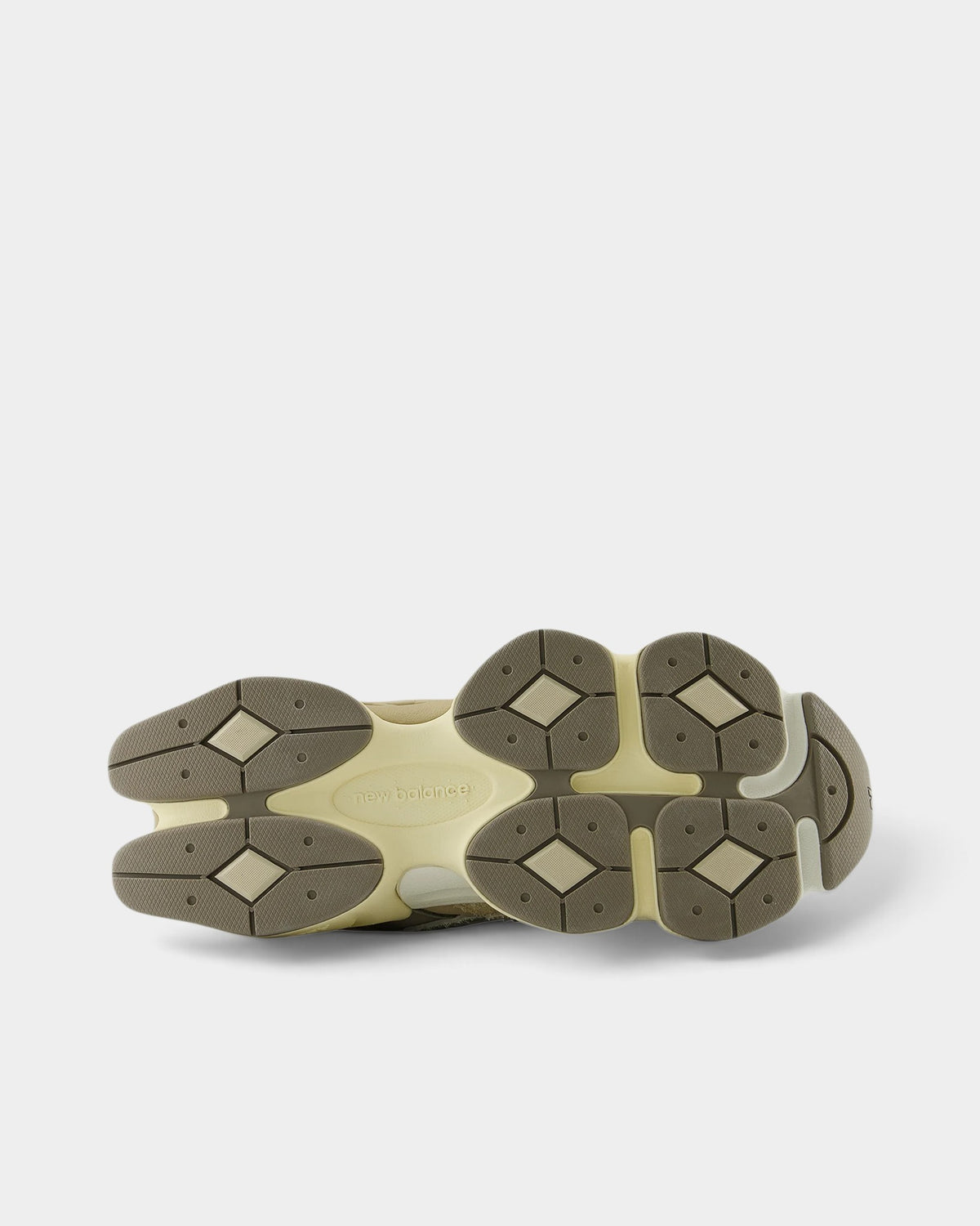 Lockwood Avenue New Balance 9060 sneakers showing the sculpted beige and olive rubber outsole with pod cushioning.