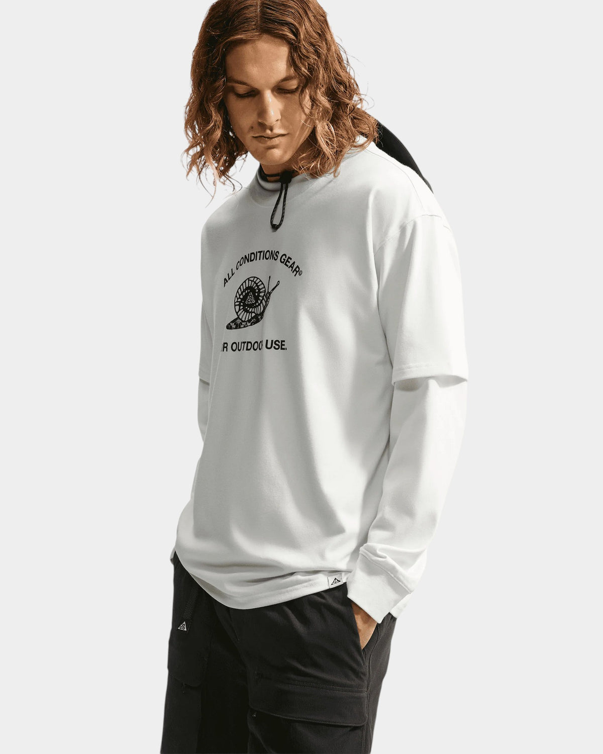 Lockwood Avenue Nike ACG white long-sleeve Dri-FIT t-shirt with a snail graphic print on the chest.