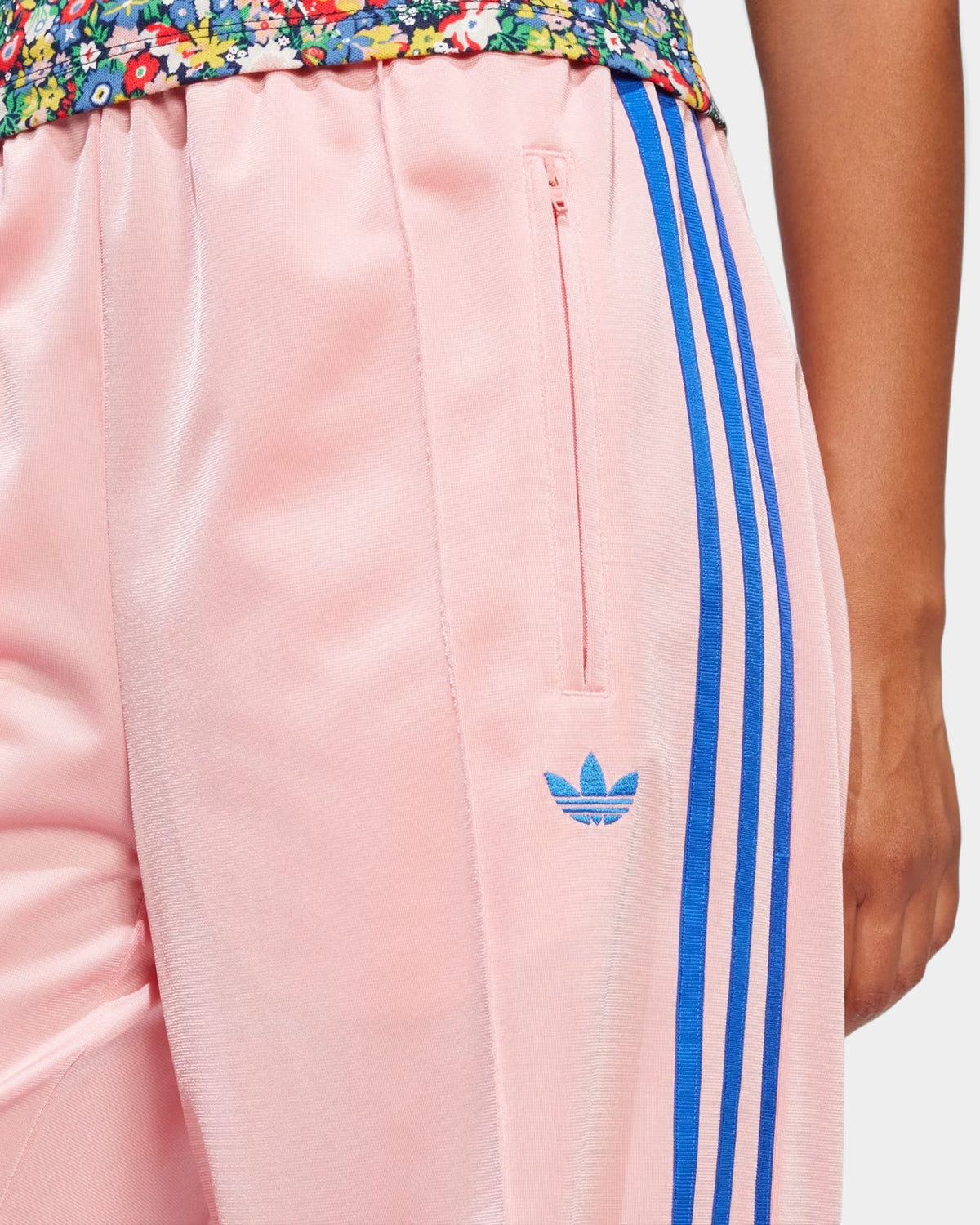 Lockwood Avenue pink tricot track pants with blue 3-Stripes and embroidered Trefoil logo on a loose-fit women's cut
