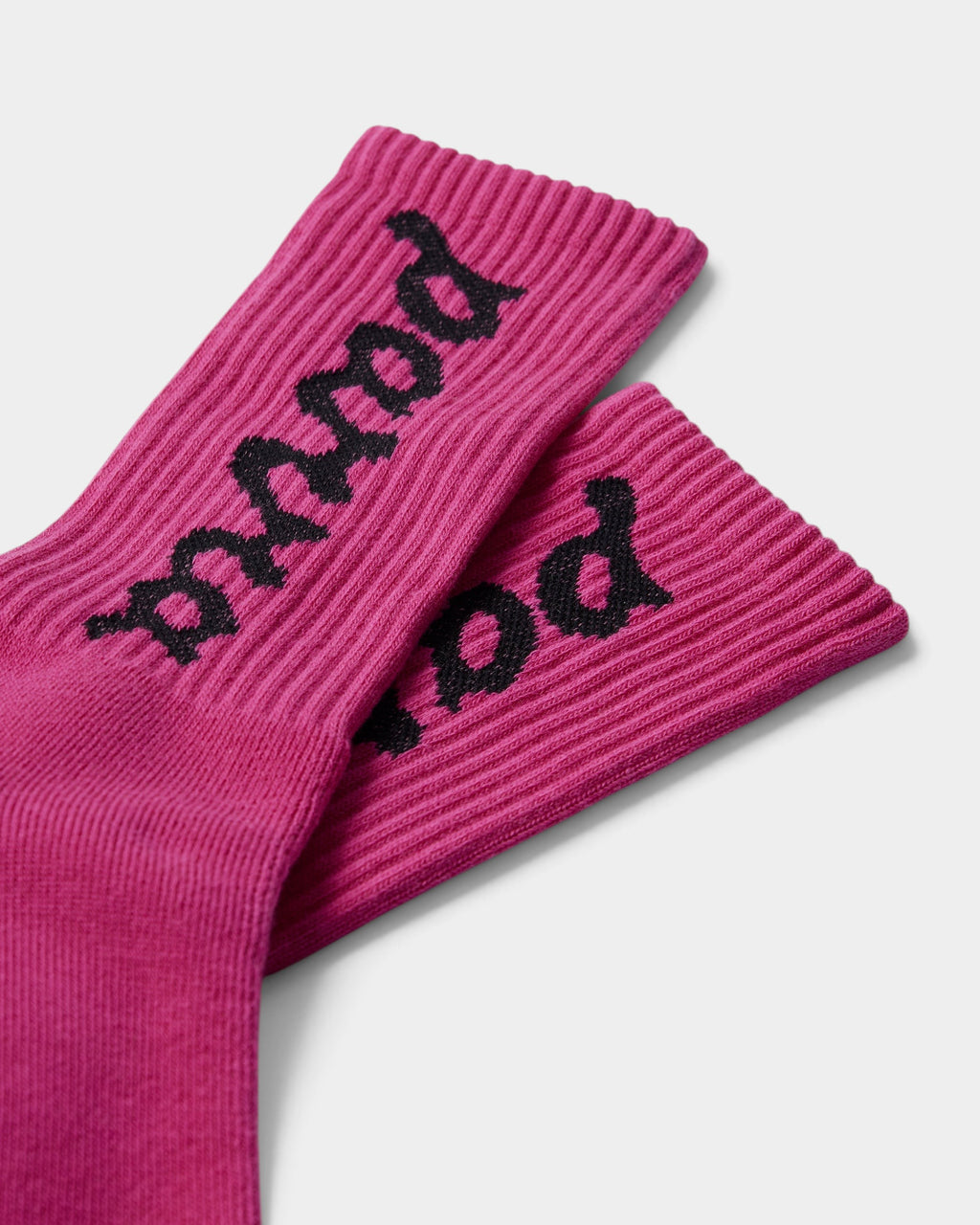 Lockwood Avenue by Parra pink crew socks with black lowercase script logo knitted on the ribbed cotton fabric