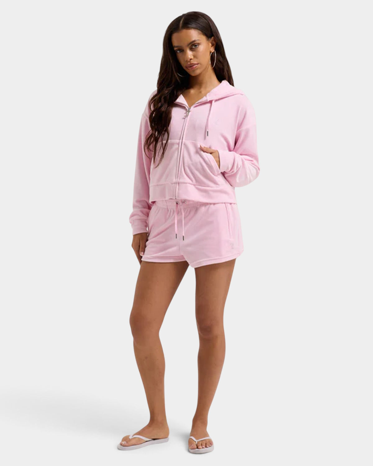 Lockwood Avenue model wearing a pink Juicy Couture velour zip-up hoodie and matching drawstring track shorts