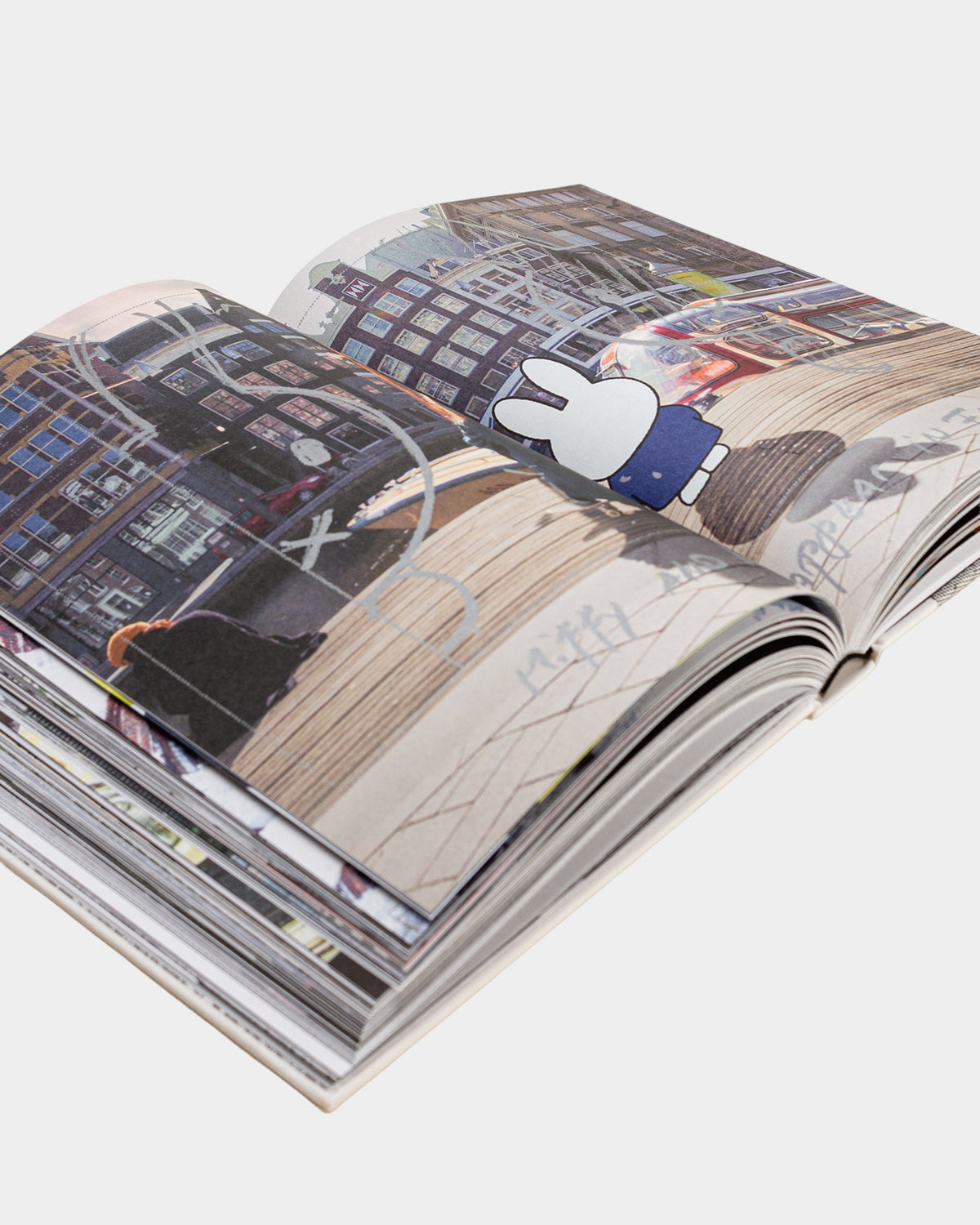 Lockwood Avenue Pop Trading Company 2013-2023 book open to a page featuring urban photography and Miffy illustration