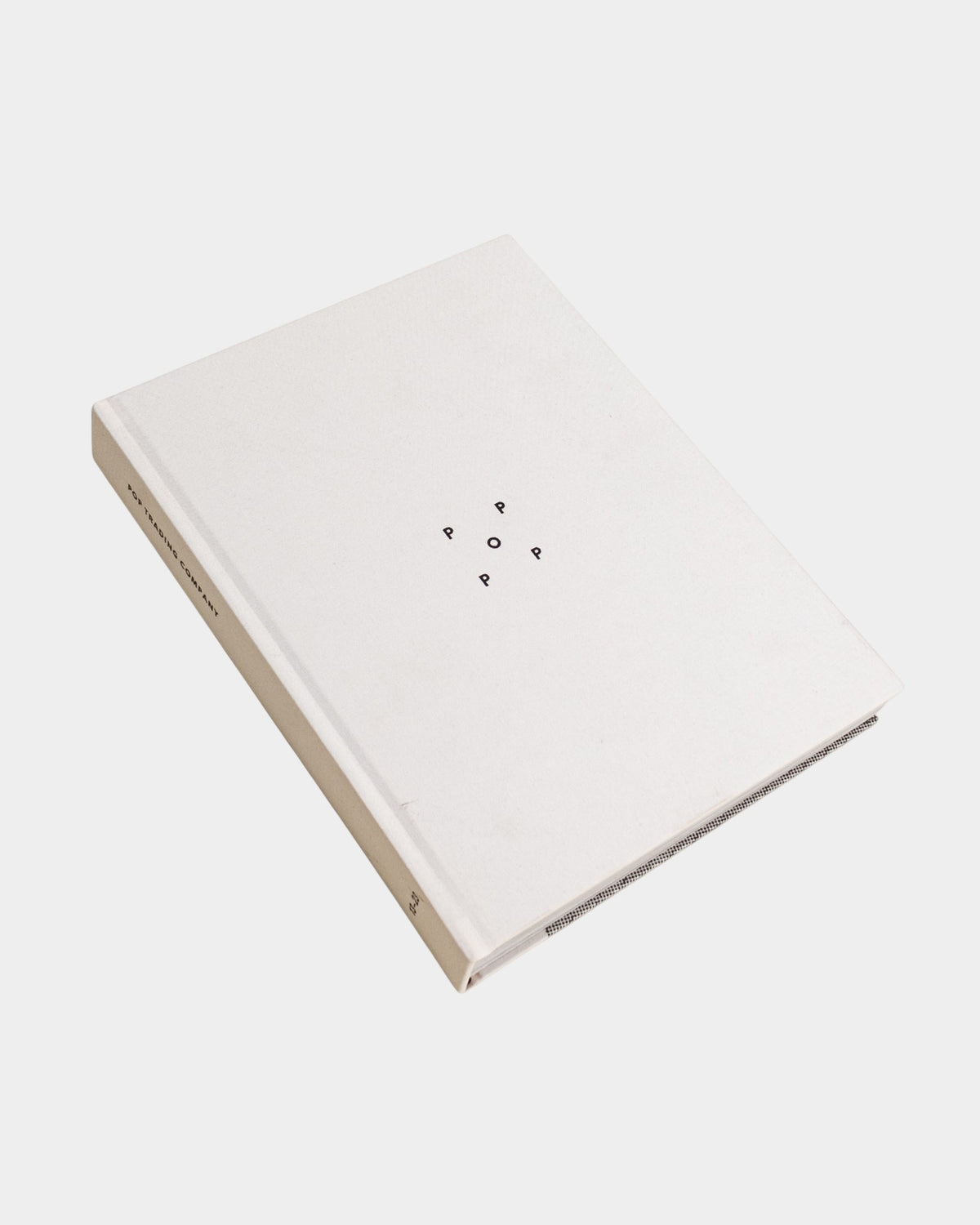 Lockwood Avenue Pop Trading Company 2013-2023 hardcover book with a white linen cover and minimalist logo design.