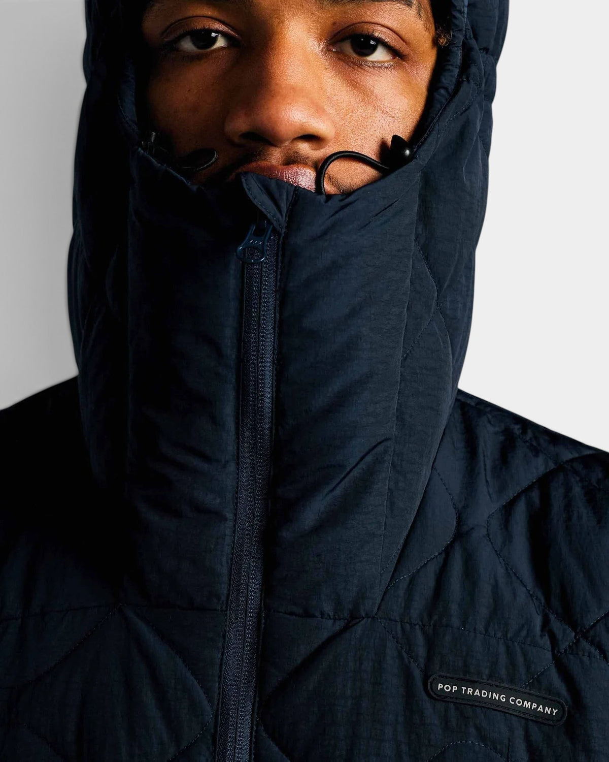 Lockwood Avenue Pop Trading Company quilted navy nylon jacket with adjustable hood and chest badge