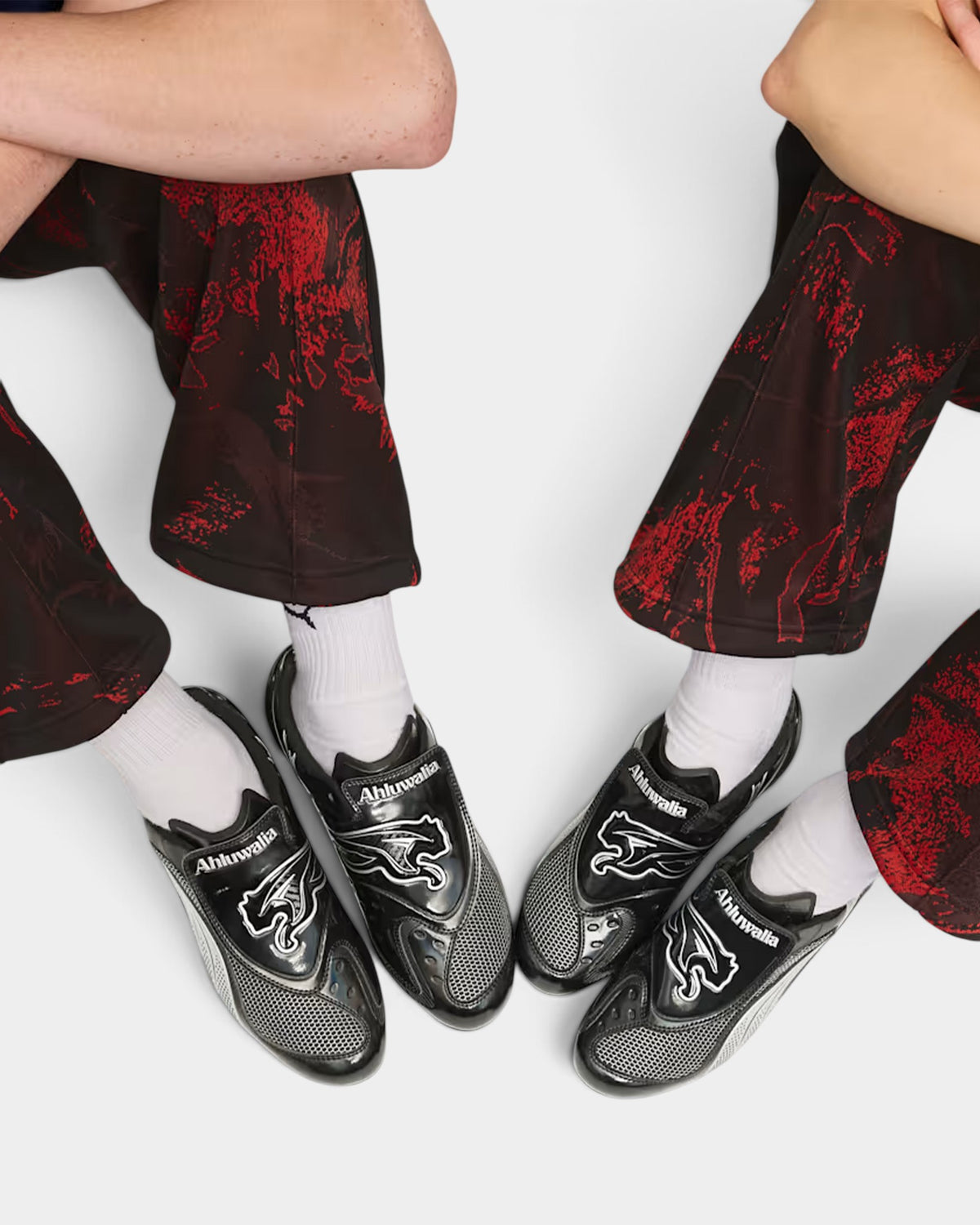 Lockwood Avenue Puma Ahluwalia V-S1 black sneakers with silver detailing and front strap on feet with patterned pants