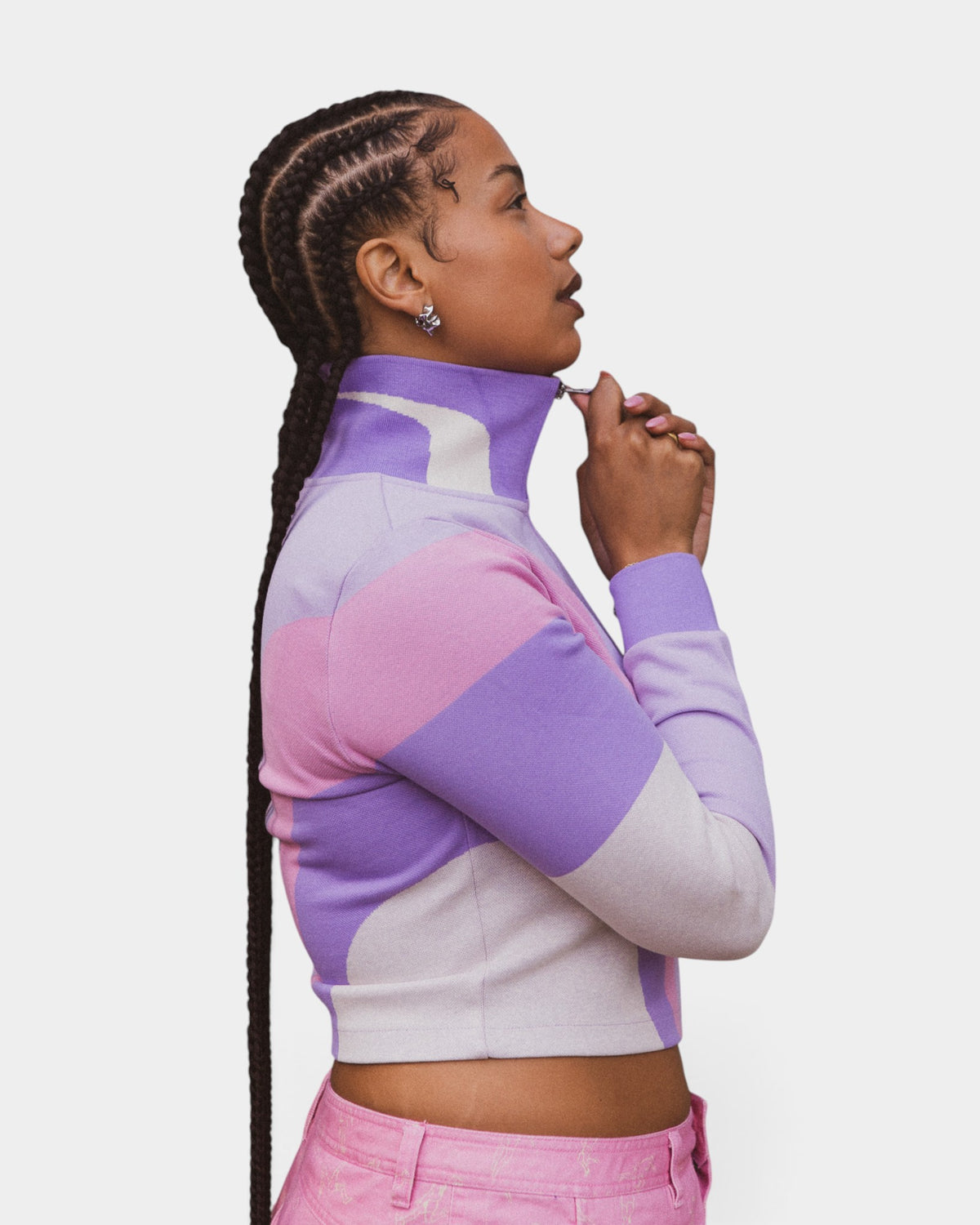 Lockwood Avenue Puma x KidSuper purple and pink jacquard knit track top with stand-up collar worn by a woman