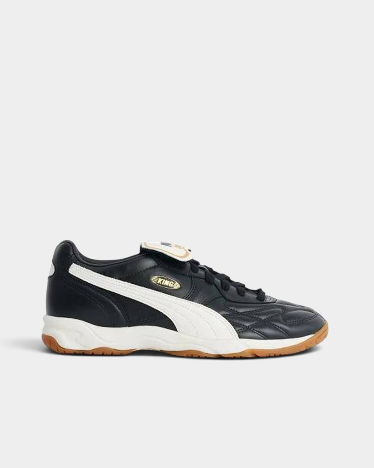 Lockwood Avenue Puma King indoor soccer shoes in black leather with a white side stripe and gum rubber outsole.