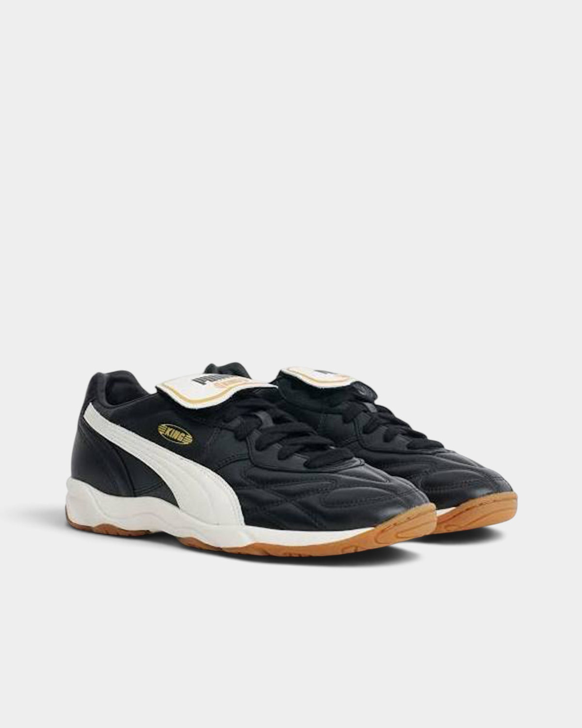Lockwood Avenue Puma King indoor soccer shoes in black leather with a white sole and removable folded tongue