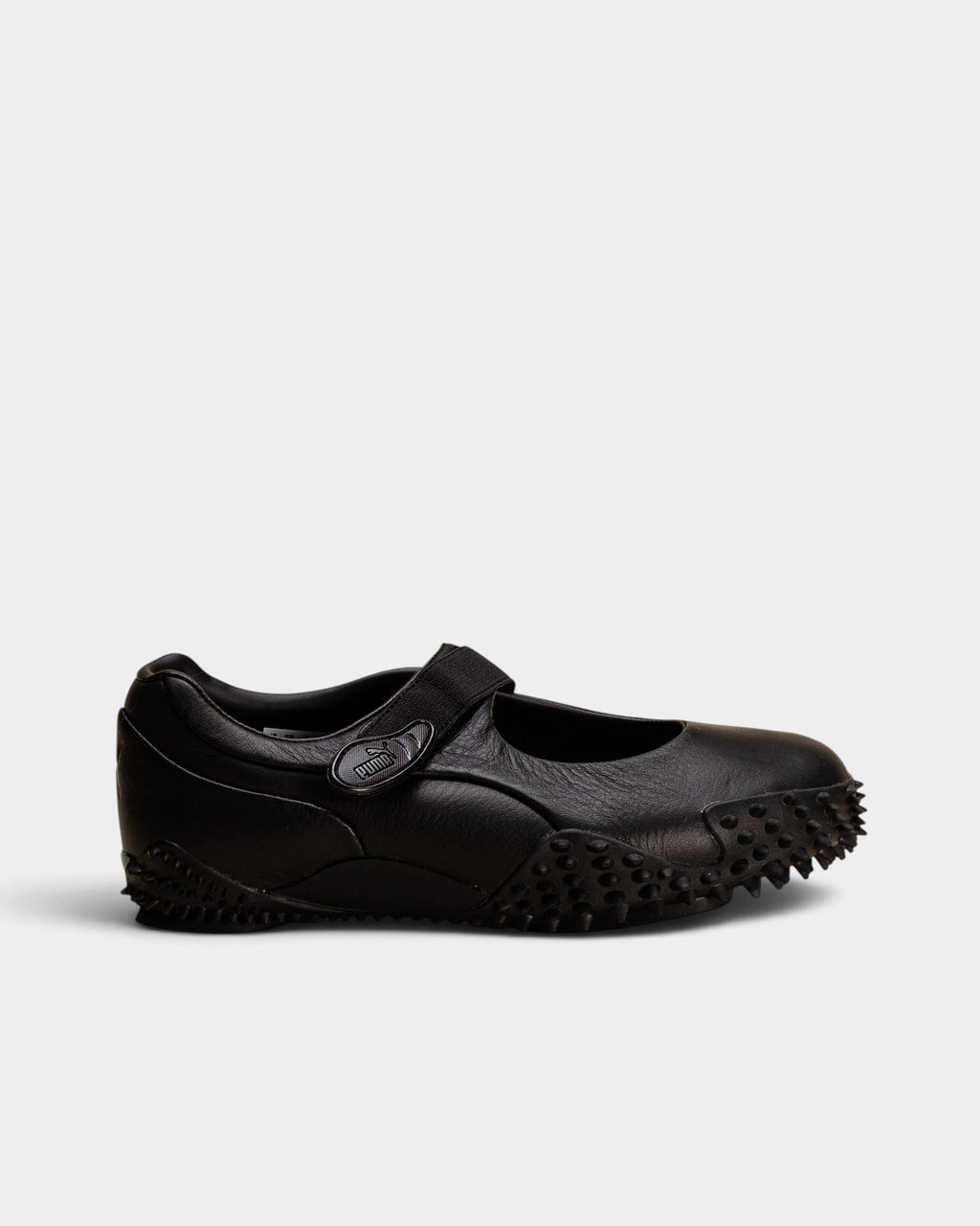 Lockwood Avenue Puma Mostro Fey LTH black leather Mary Jane shoes with a single strap and spiked rubber outsole.