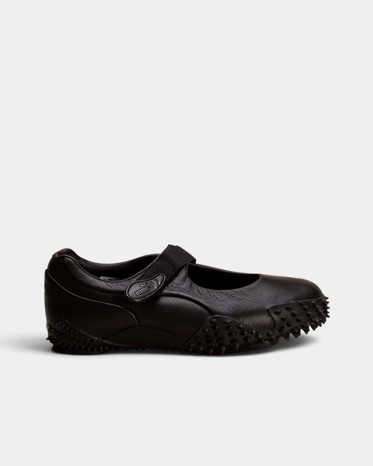 Lockwood Avenue Puma Mostro Fey LTH black leather Mary Jane shoes with a single strap and spiked rubber outsole.