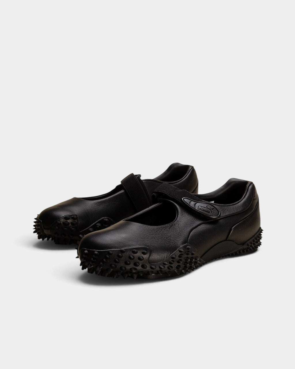 Lockwood Avenue Puma Mostro Fey LTH black leather Mary Jane shoes with a single strap and spiked rubber outsole.