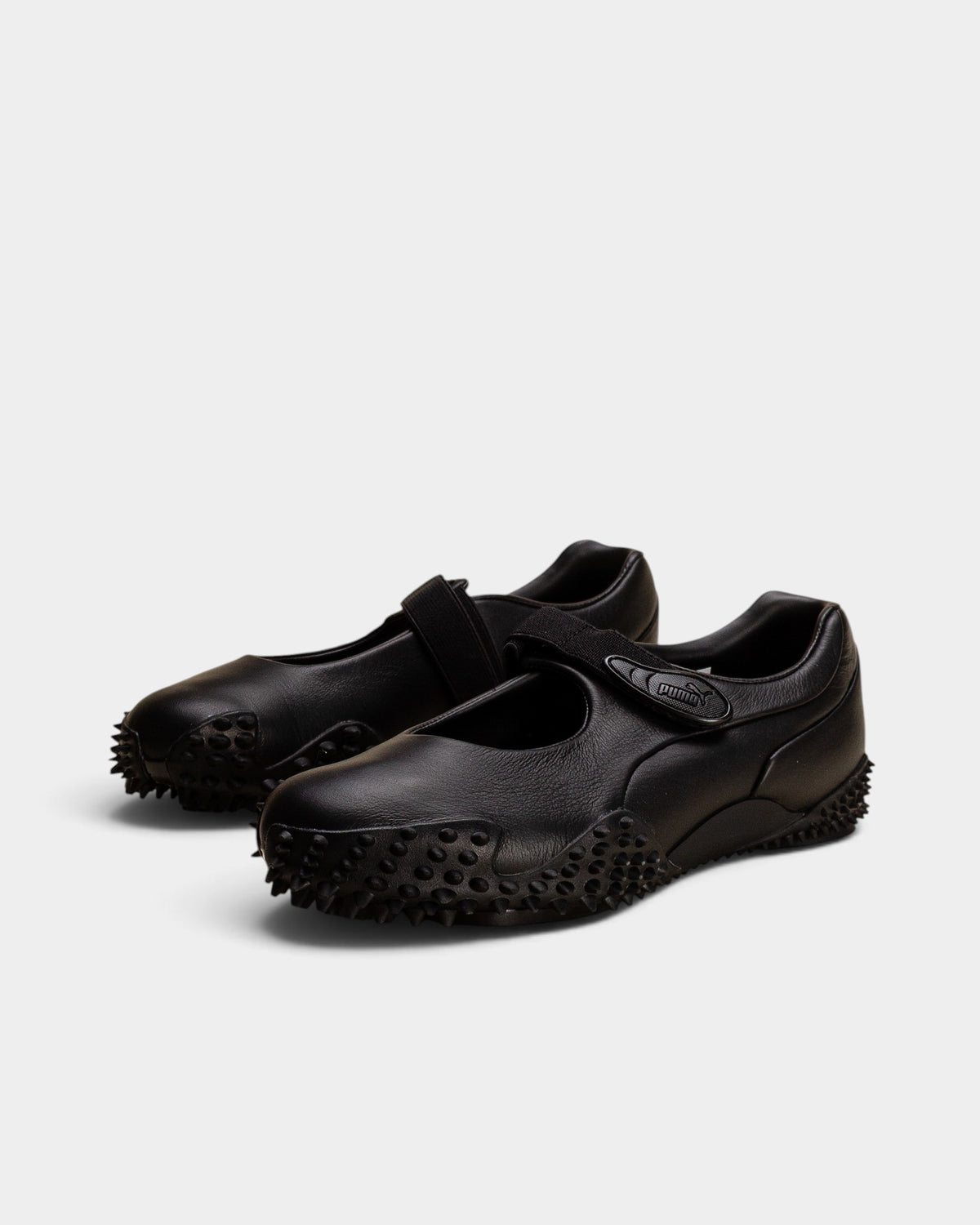 Lockwood Avenue Puma Mostro Fey LTH black leather Mary Jane shoes with a single strap and spiked rubber outsole.