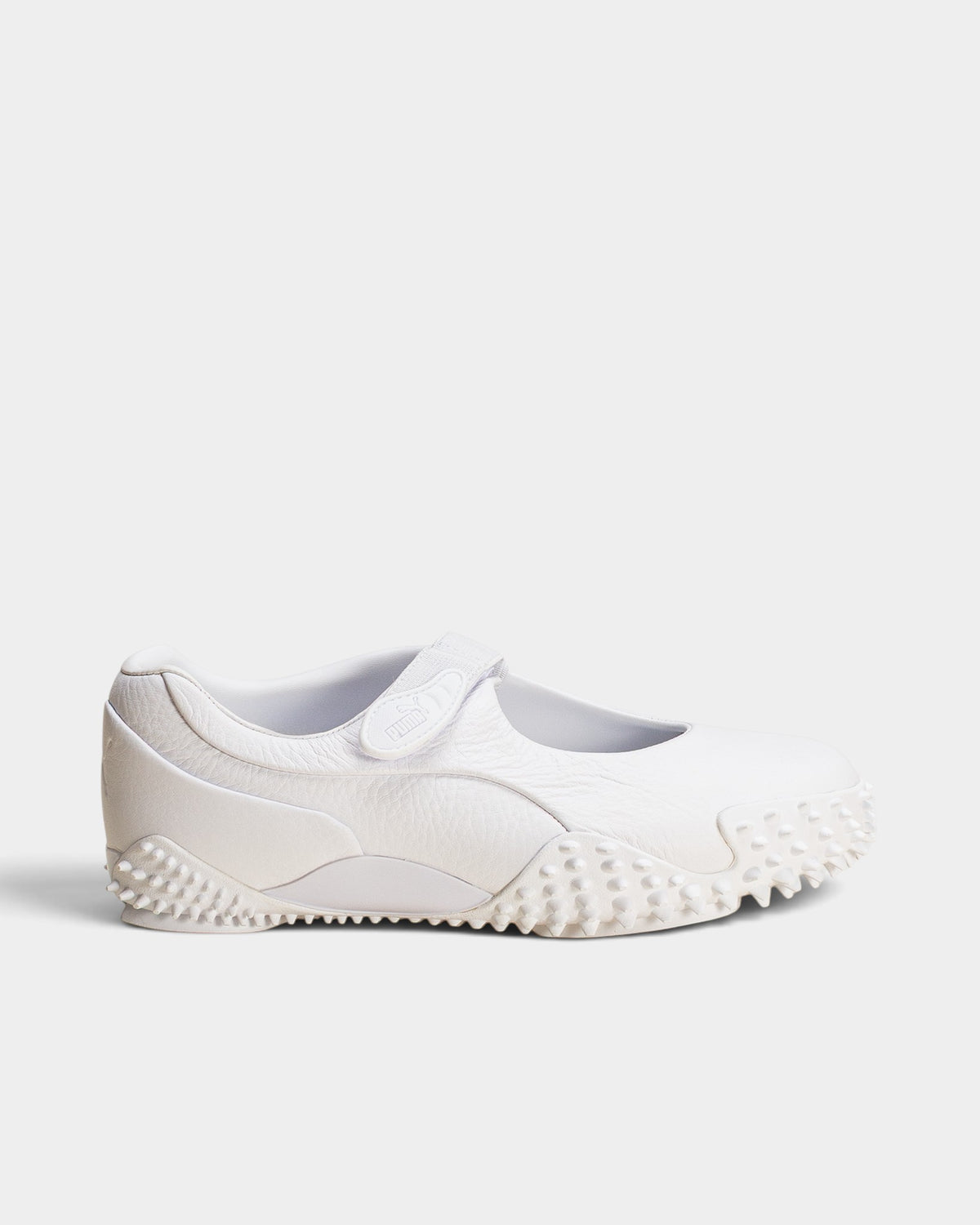 Lockwood Avenue Puma Mostro Fey LTH white leather Mary Jane shoes with a single strap and spiked rubber outsole.