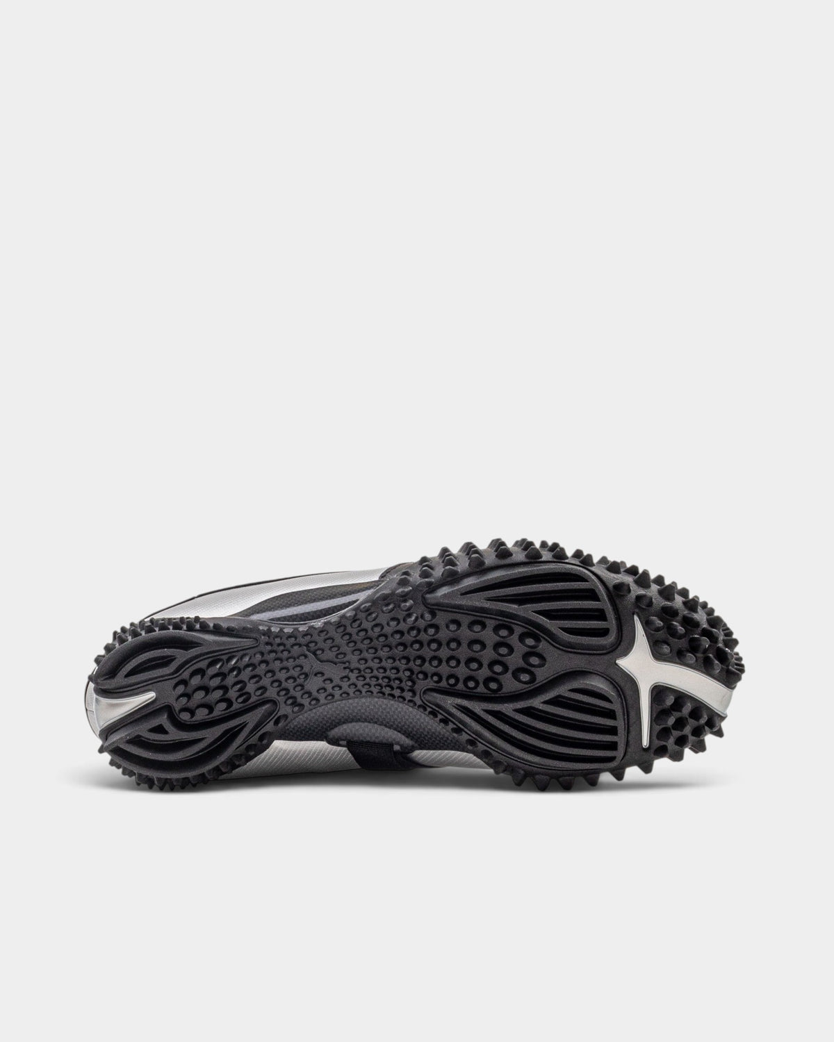 Lockwood Avenue Puma Mostro Metal sneaker showing the black spiked rubber outsole and metallic silver side profile.