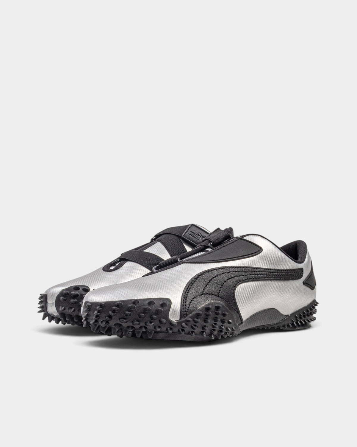 Lockwood Avenue Puma Mostro Metal shoes in metallic silver synthetic leather with black spiked rubber outsoles.