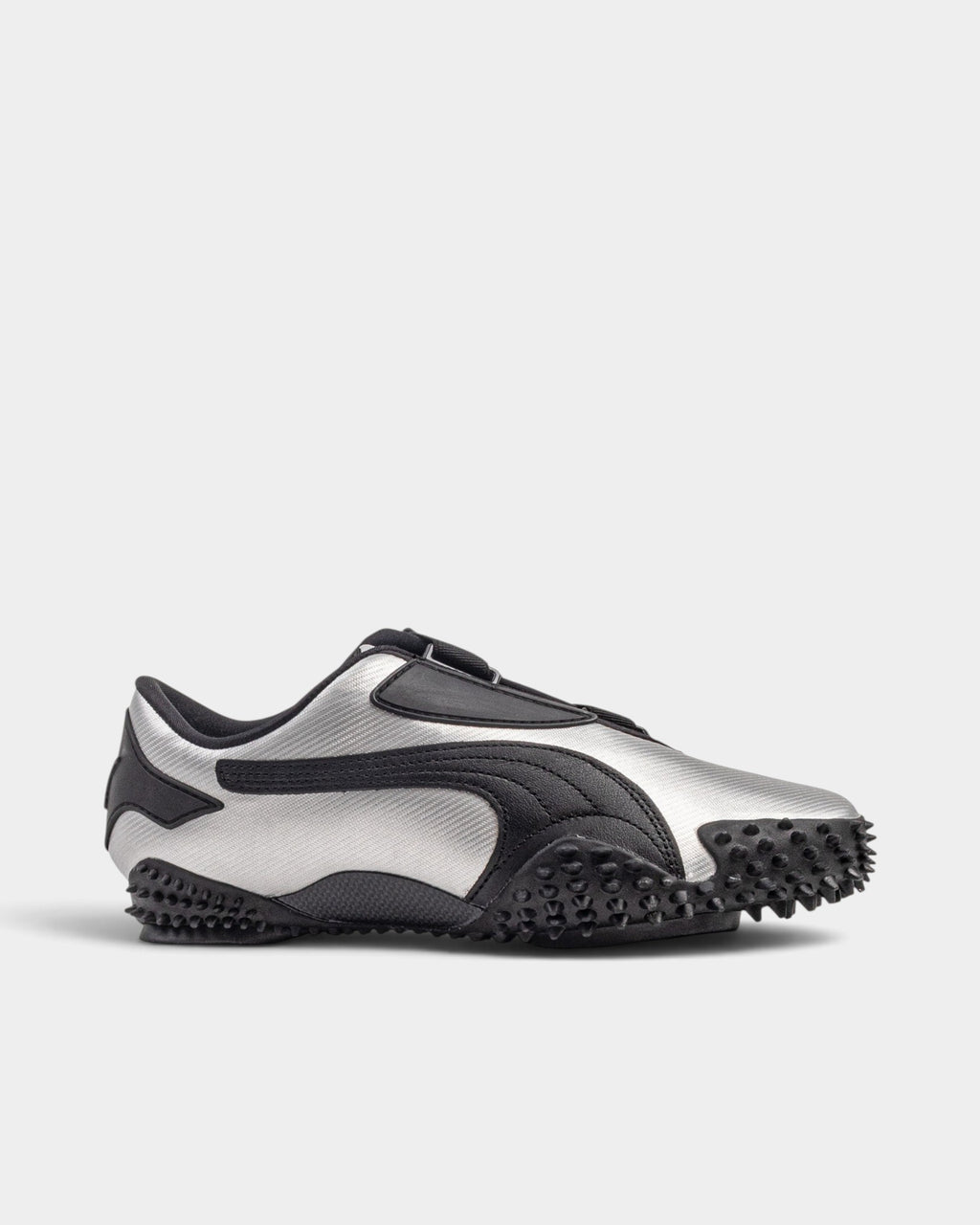 Lockwood Avenue Puma Mostro Metal sneakers in metallic silver synthetic leather with black spiked rubber outsole.