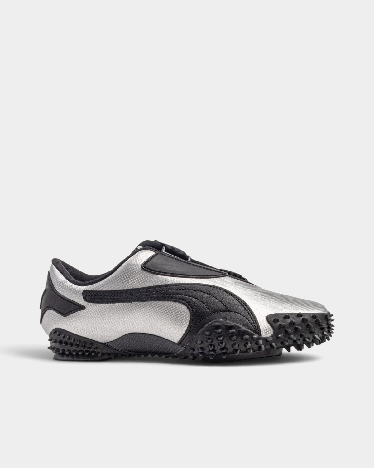 Lockwood Avenue Puma Mostro Metal sneakers in metallic silver synthetic leather with black spiked rubber outsole.