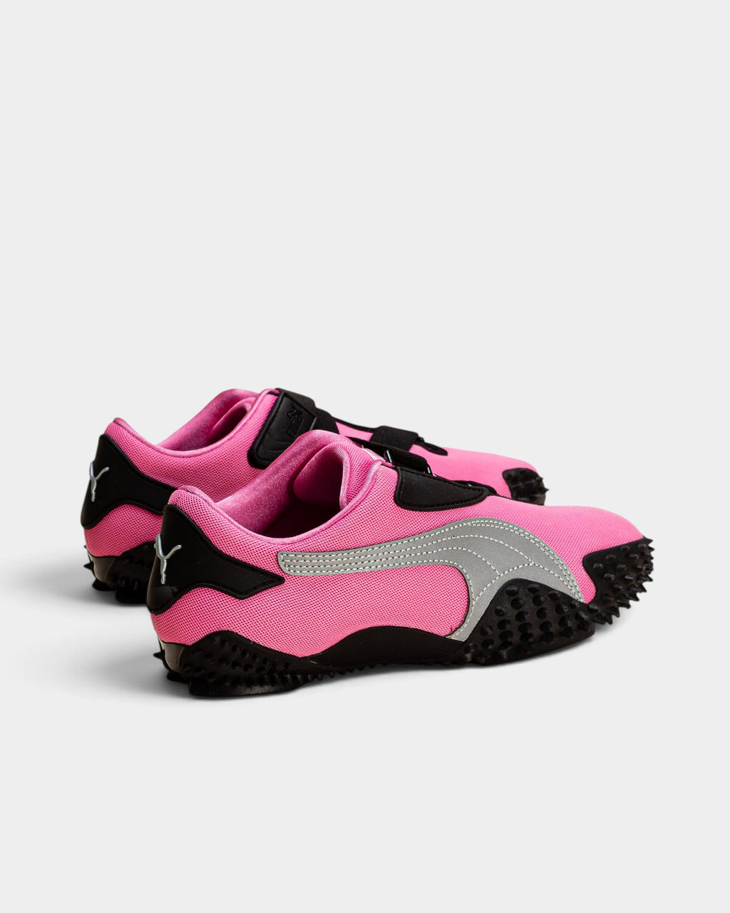 Lockwood Avenue Puma Mostro OG sneakers in Posie Pink with silver accents, hook-and-loop straps, and spiked outsoles.