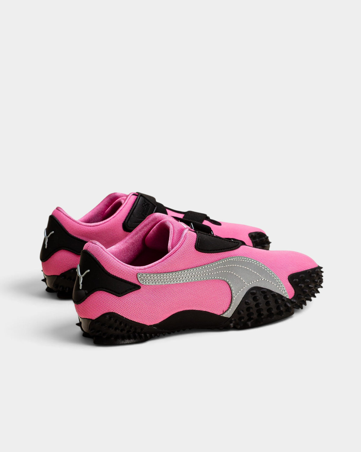Lockwood Avenue Puma Mostro OG sneakers in Posie Pink with silver accents, hook-and-loop straps, and spiked outsoles.