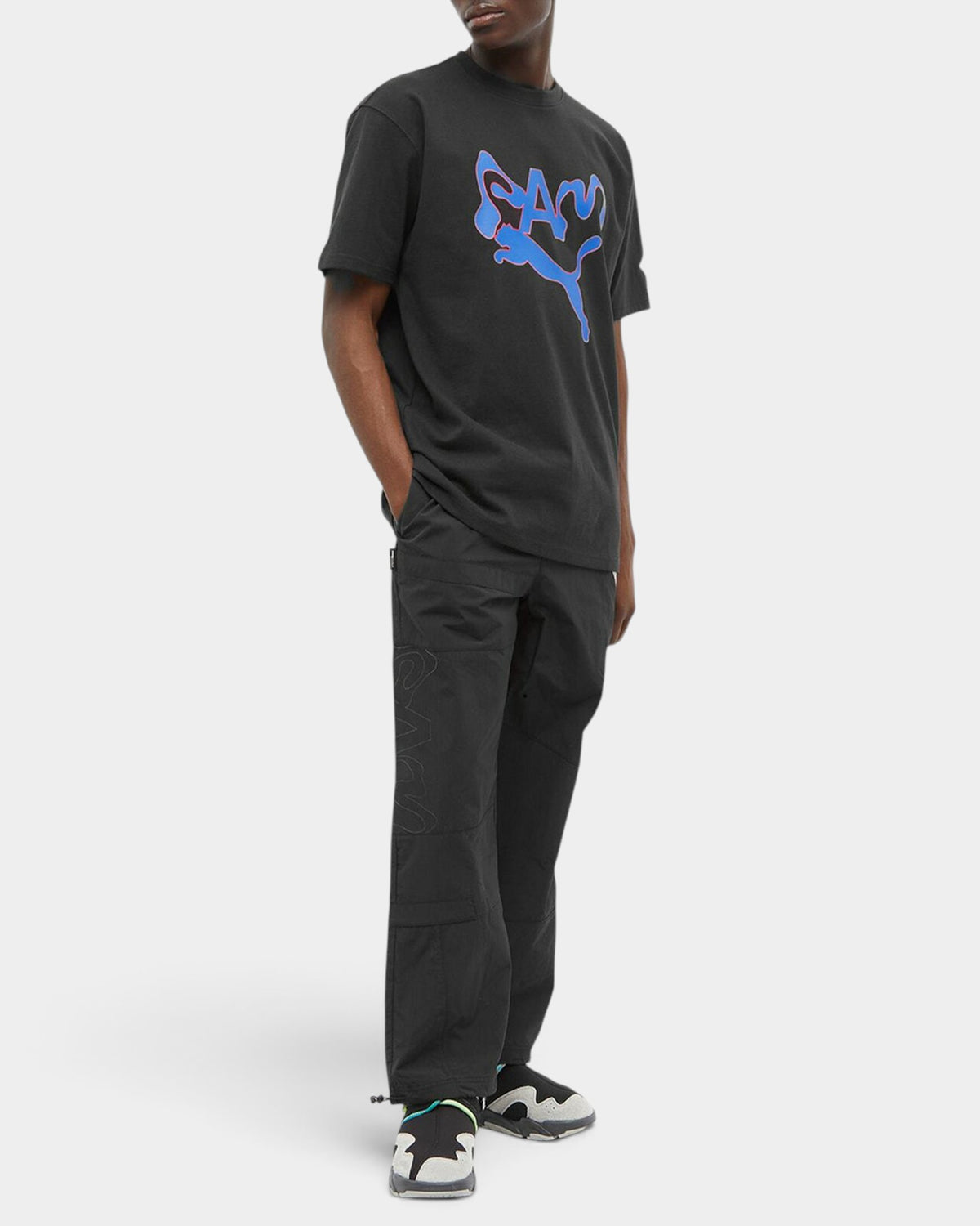 Lockwood Avenue model wearing black Puma x Perks And Mini technical nylon Cordura pants with bungee cord details