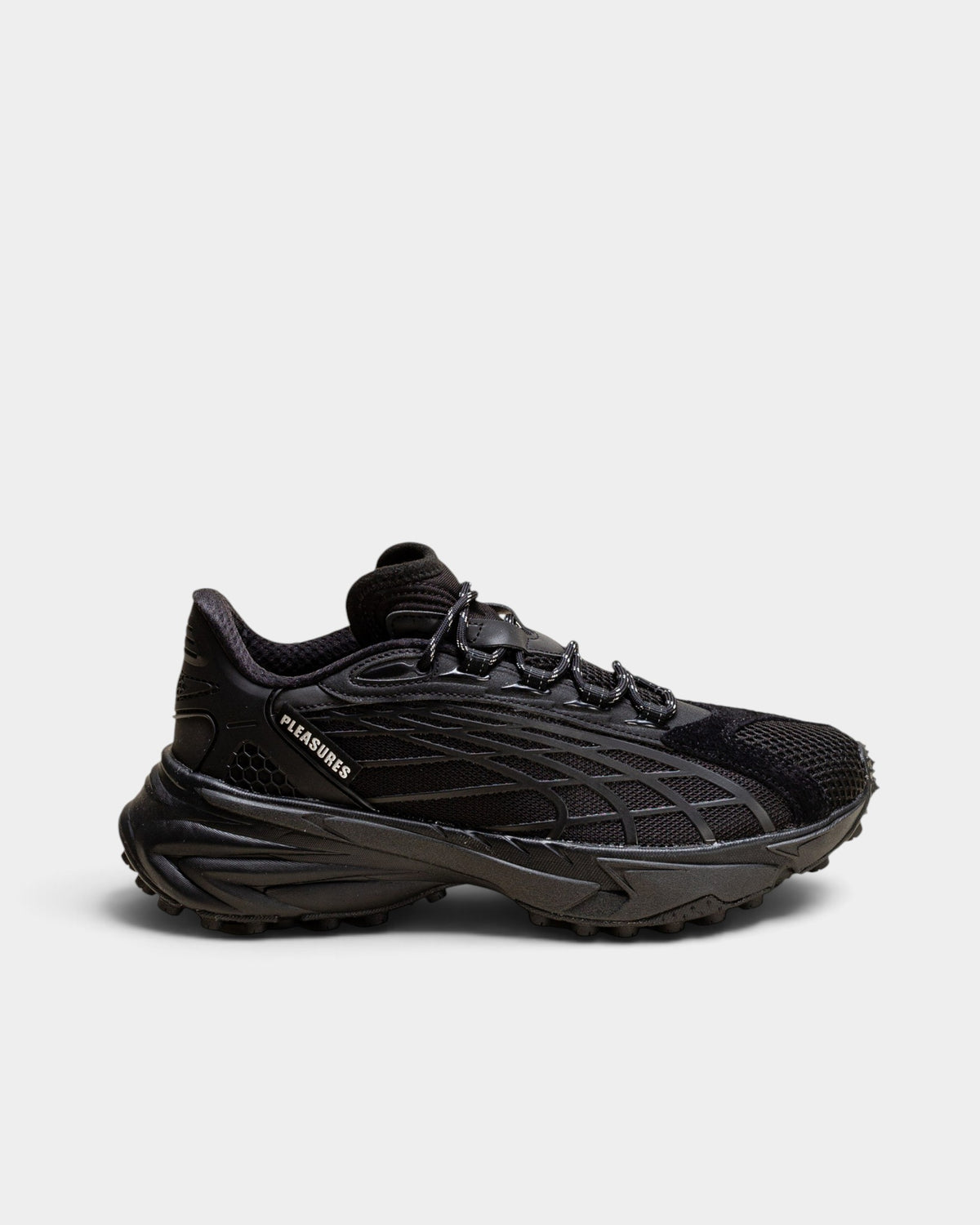 Lockwood Avenue Puma x PLEASURES Spirex black sneakers featuring mesh, hairy suede, and a spike-runner outsole.