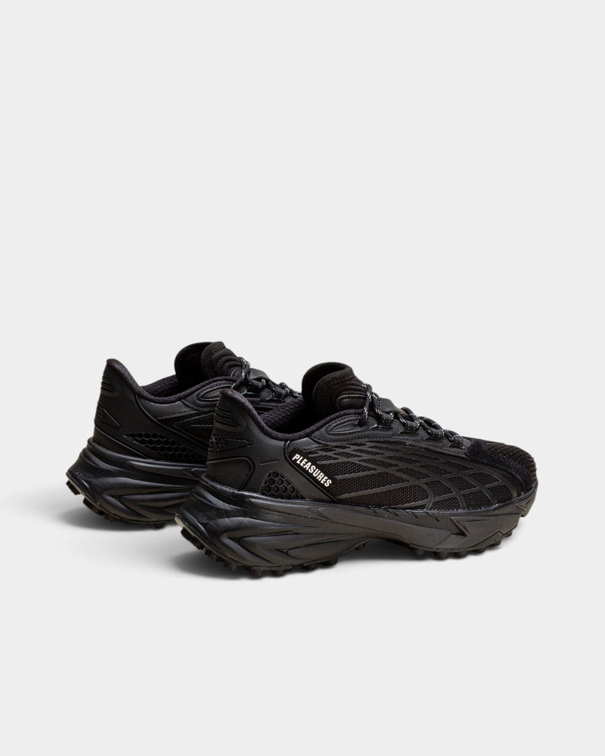 Lockwood Avenue Puma x PLEASURES Spirex black sneakers with mesh, suede, and TPU overlays in a side profile view.