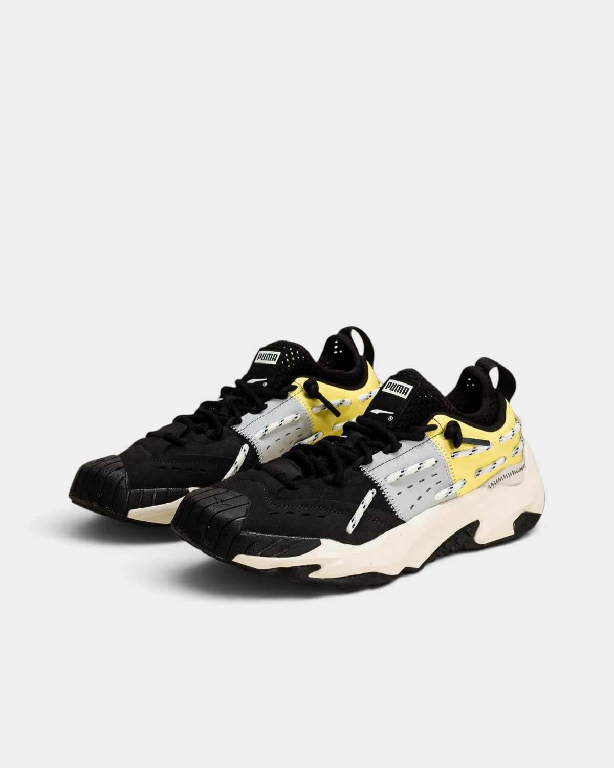 Lockwood Avenue Puma Plexus Retro shoes in black nubuck, leather, and suede with pale lemon accents and chunky sole.