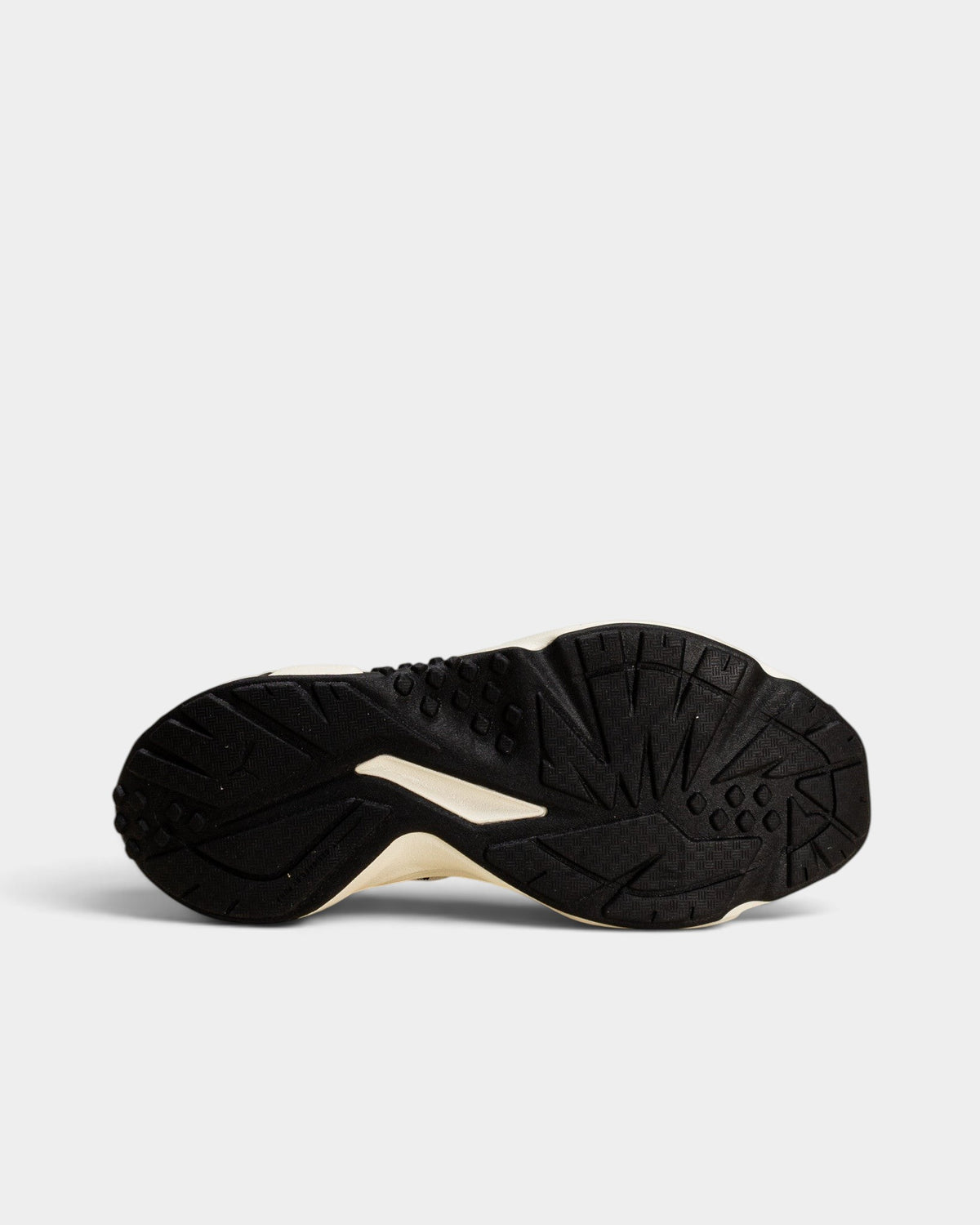 Lockwood Avenue Puma Plexus Retro shoe showing the black and pale lemon rubber outsole tread pattern