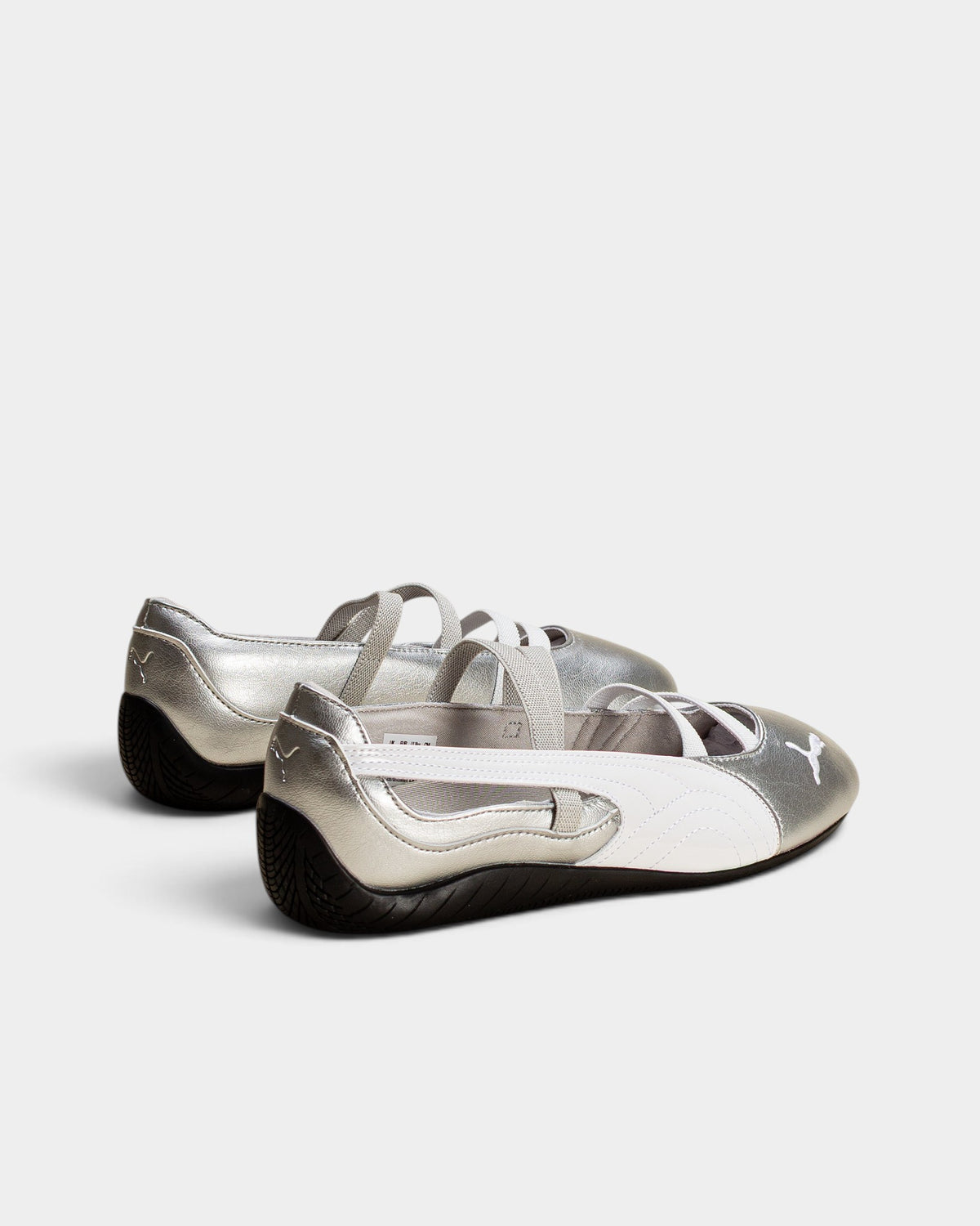 Lockwood Avenue Puma Speedcat Ballet metallic silver leather flats with white elastic straps and rubber outsoles.