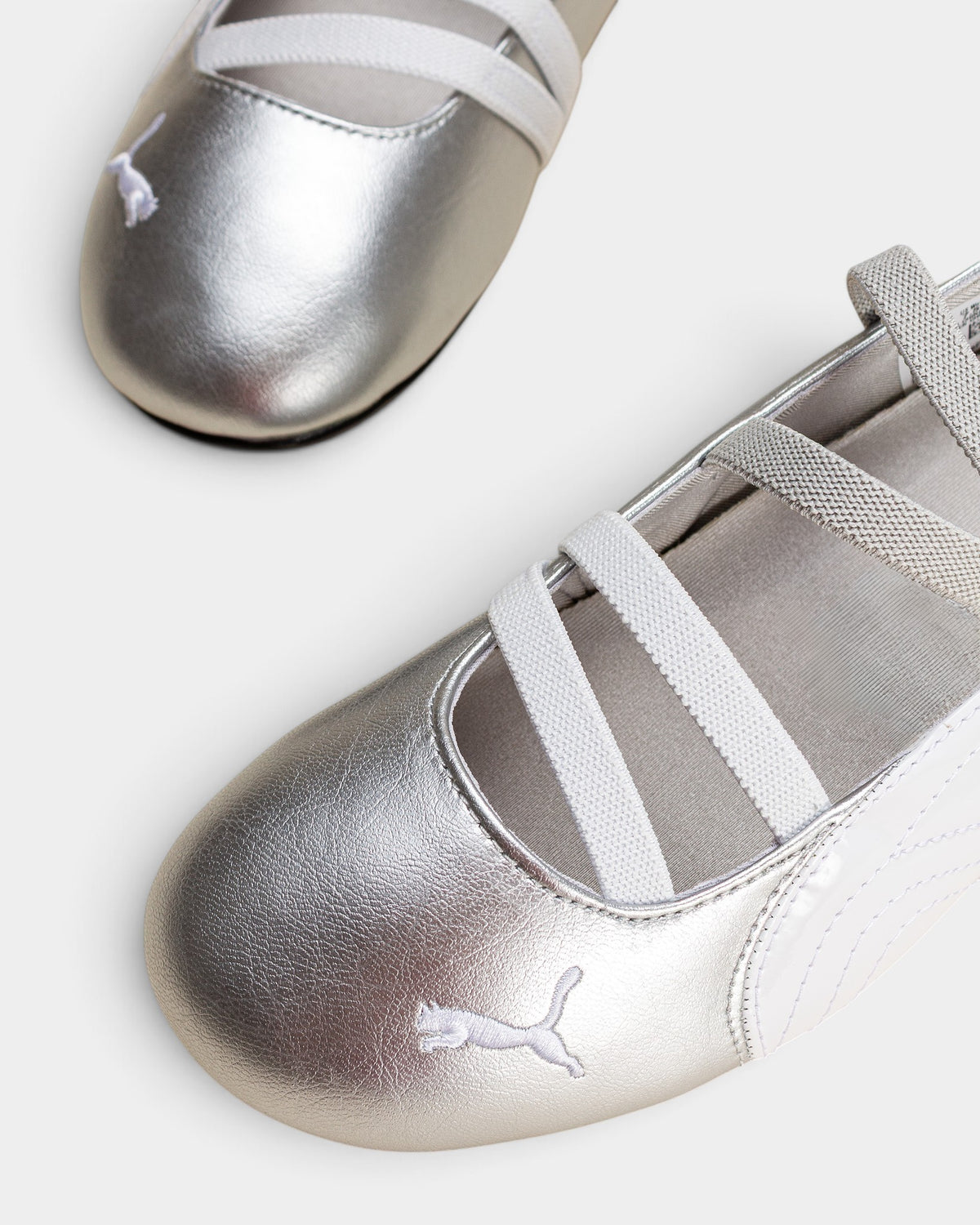 Lockwood Avenue Puma Speedcat Ballet metallic silver leather flats with white elastic straps and embroidered cat logo.