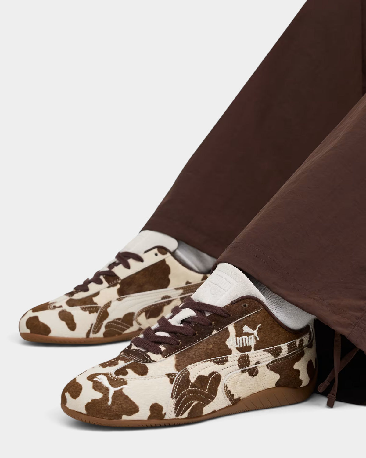 Lockwood Avenue Puma Speedcat shoes in cream and brown faux cow-hair with a gum rubber sole and motorsport silhouette.