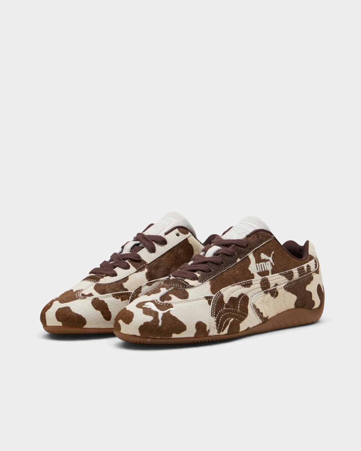 Lockwood Avenue Puma Speedcat shoes featuring a cream and brown cow-print faux hair upper and gum rubber outsole.