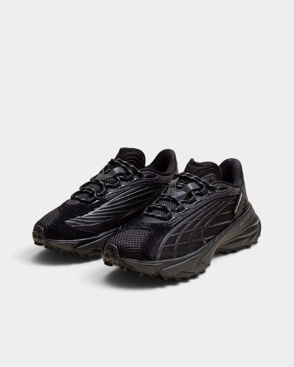 Lockwood Avenue Puma Spirex x PLEASURES black sneakers with mesh, suede, and TPU overlays on a spike-runner outsole.