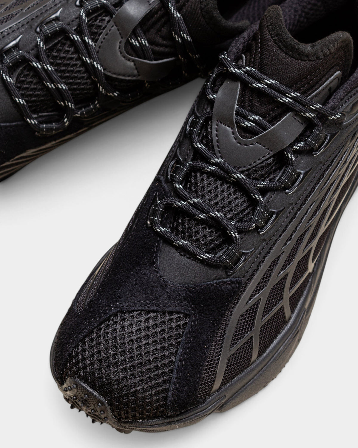 Lockwood Avenue Puma Spirex x PLEASURES black sneakers featuring mesh, hairy suede, and reflective laces.