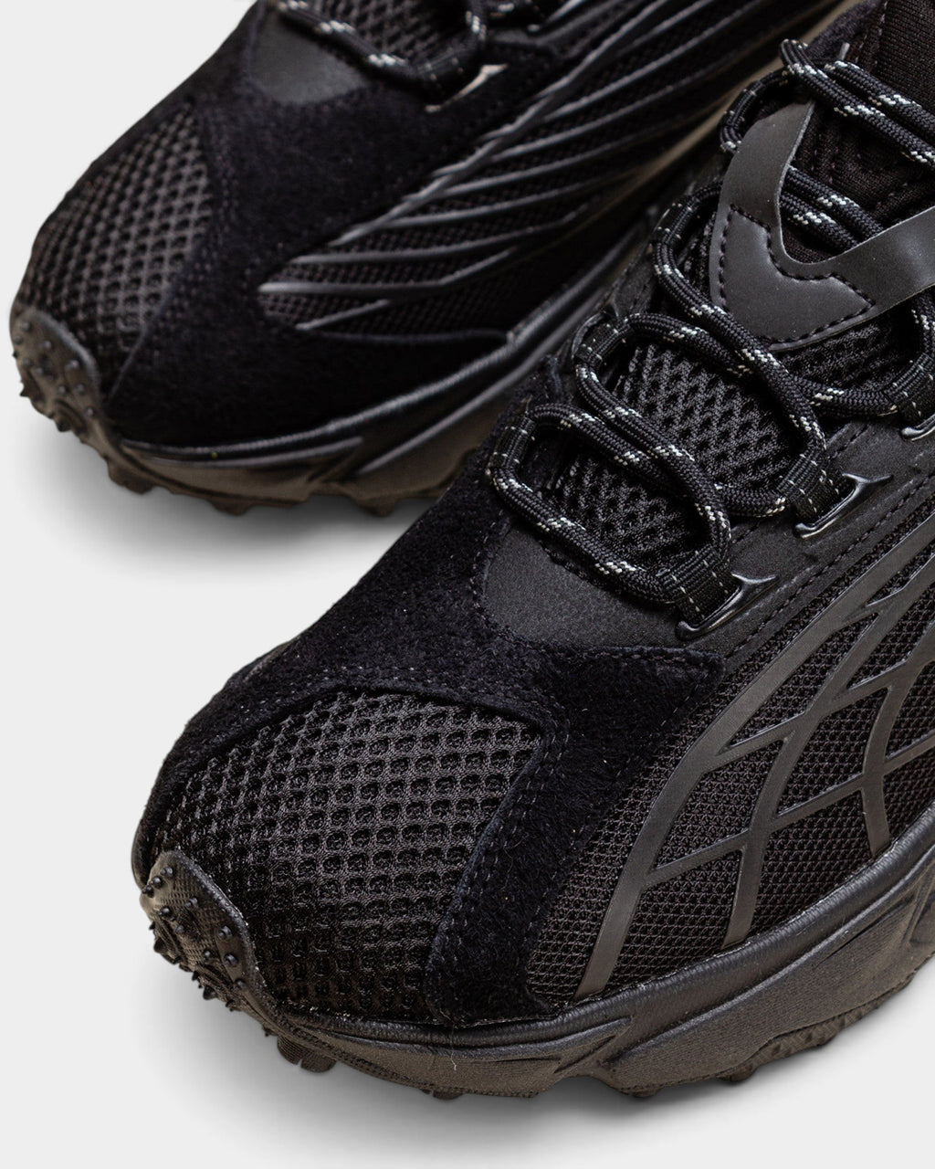 Lockwood Avenue Puma Spirex x PLEASURES black sneakers featuring mesh, hairy suede, and TPU overlays.