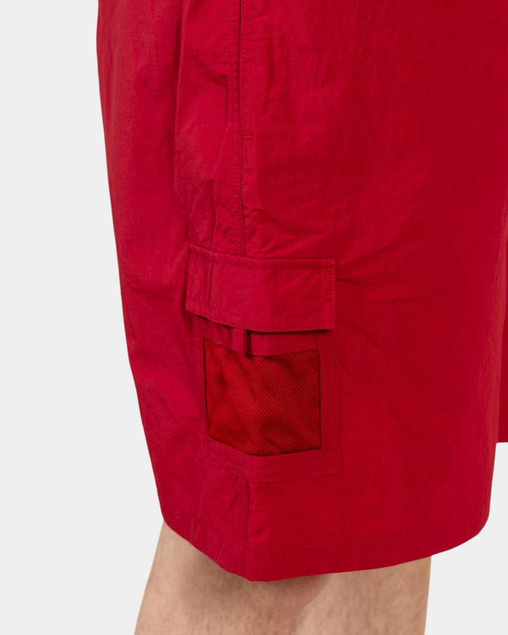 Lockwood Avenue Pop Trading Company red nylon painter shorts featuring a side cargo pocket with a mesh window detail.
