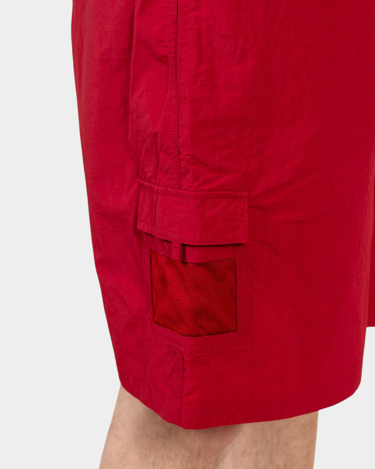Lockwood Avenue Pop Trading Company red nylon painter shorts featuring a side cargo pocket with a mesh window detail.