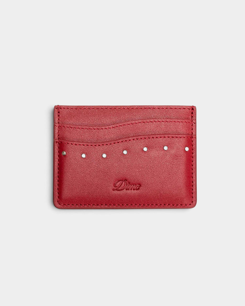 Lockwood Avenue red leather cardholder featuring metal studs and an embossed Dime logo on the front