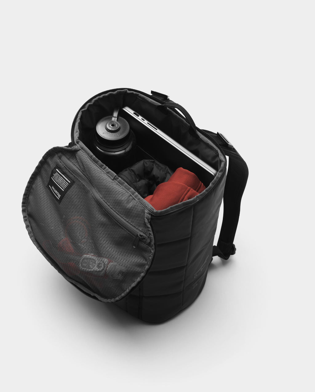 Lockwood Avenue DB Journey Roamer 25L black barrel duffel backpack with open lid showing internal mesh pocket