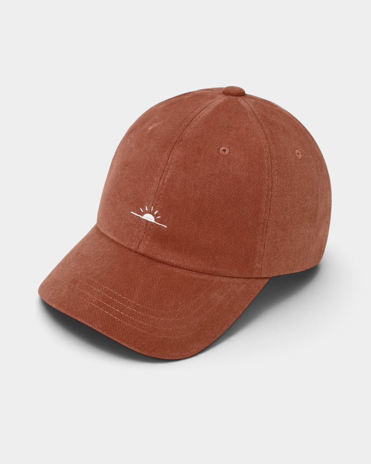 Lockwood Avenue Kappy washed cotton ball cap in rust red with a small white embroidered sunrise motif on the front.