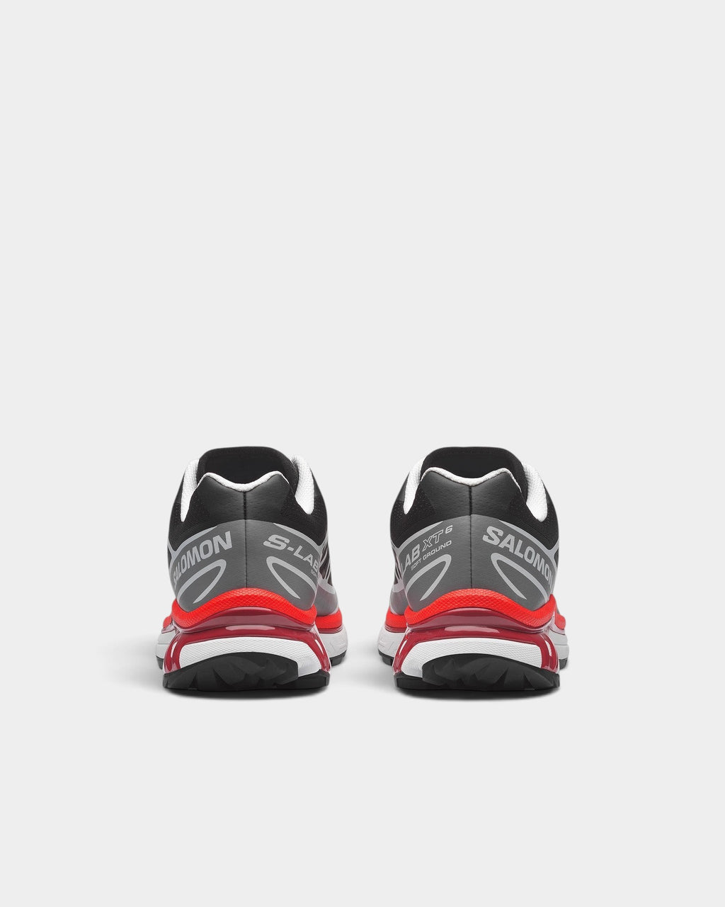 Lockwood Avenue Salomon XT-6 trail running shoes in black, grey, and red, showing the rear view of the heels.