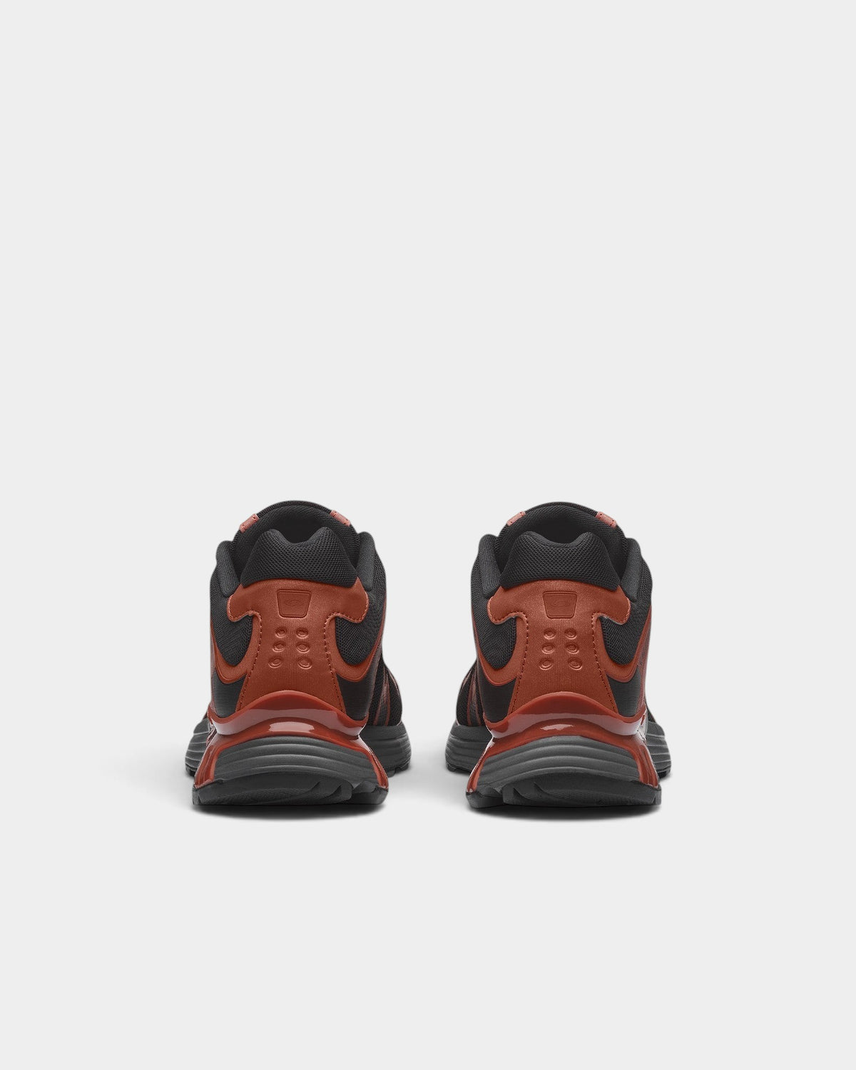 Lockwood Avenue Salomon XT-Whisper trail shoes in black and rust brown, rear view showing heel and sole detail.