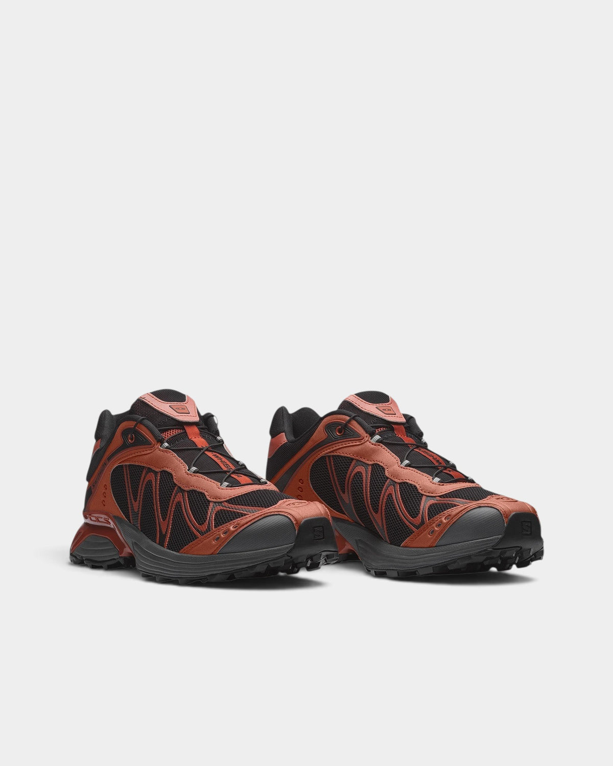 Lockwood Avenue Salomon XT-Whisper trail shoes in rust orange and black with wavy mesh panels and Quicklace system.
