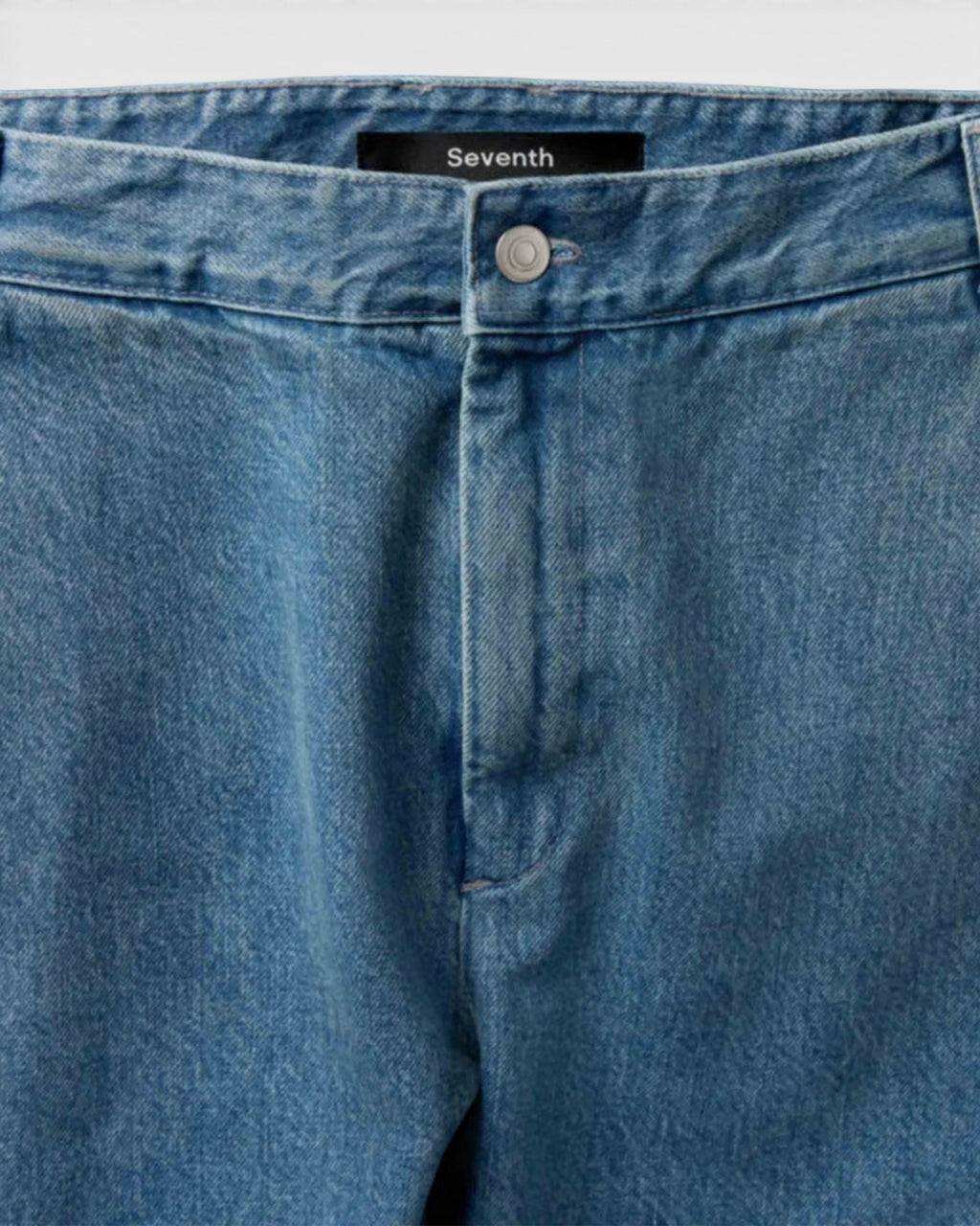 Lockwood Avenue Seventh V10 denim Bermuda jeans featuring a faded vintage wash, front button closure, and label tag.
